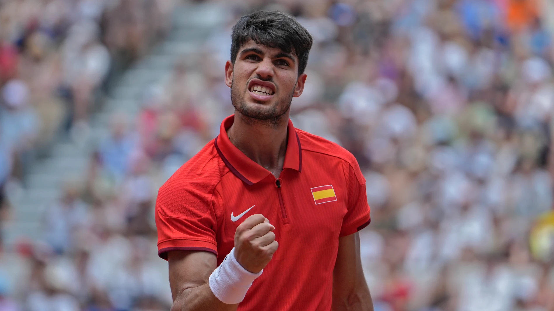 Carlos Alcaraz of Spain reacts after scoring a point against Roman Safiullin of Russia during their men's singles third round match, at the 2024 Summer Olympics, Wednesday, July 31, 2024, at the Roland Garros stadium in Paris, France. (AP Photo/Andy Wong)