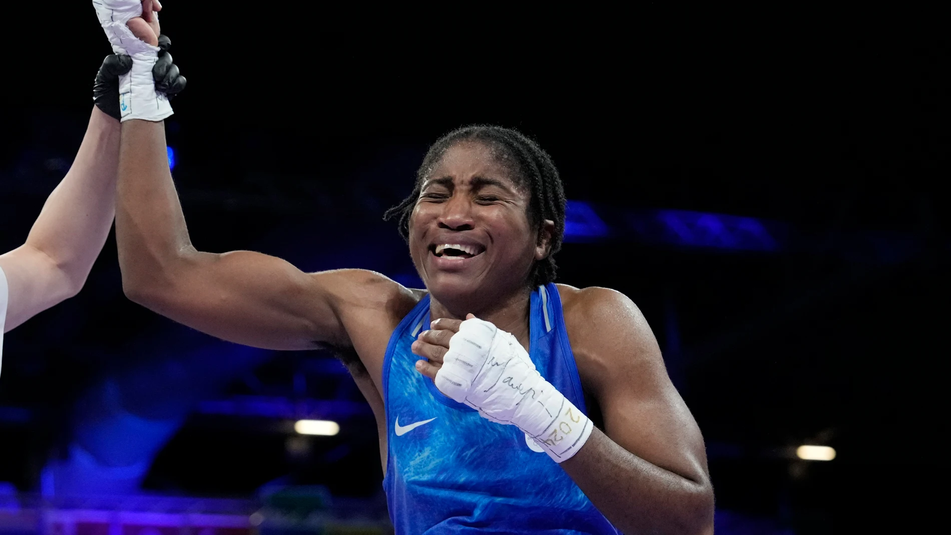 Refugee Olympic Team's Cindy Ngamba celebrates after defeating Canada's Tammara Thibeault in their women's 75 kg preliminary boxing match at the 2024 Summer Olympics, Wednesday, July 31, 2024, in Paris, France. (AP Photo/Ariana Cubillos)