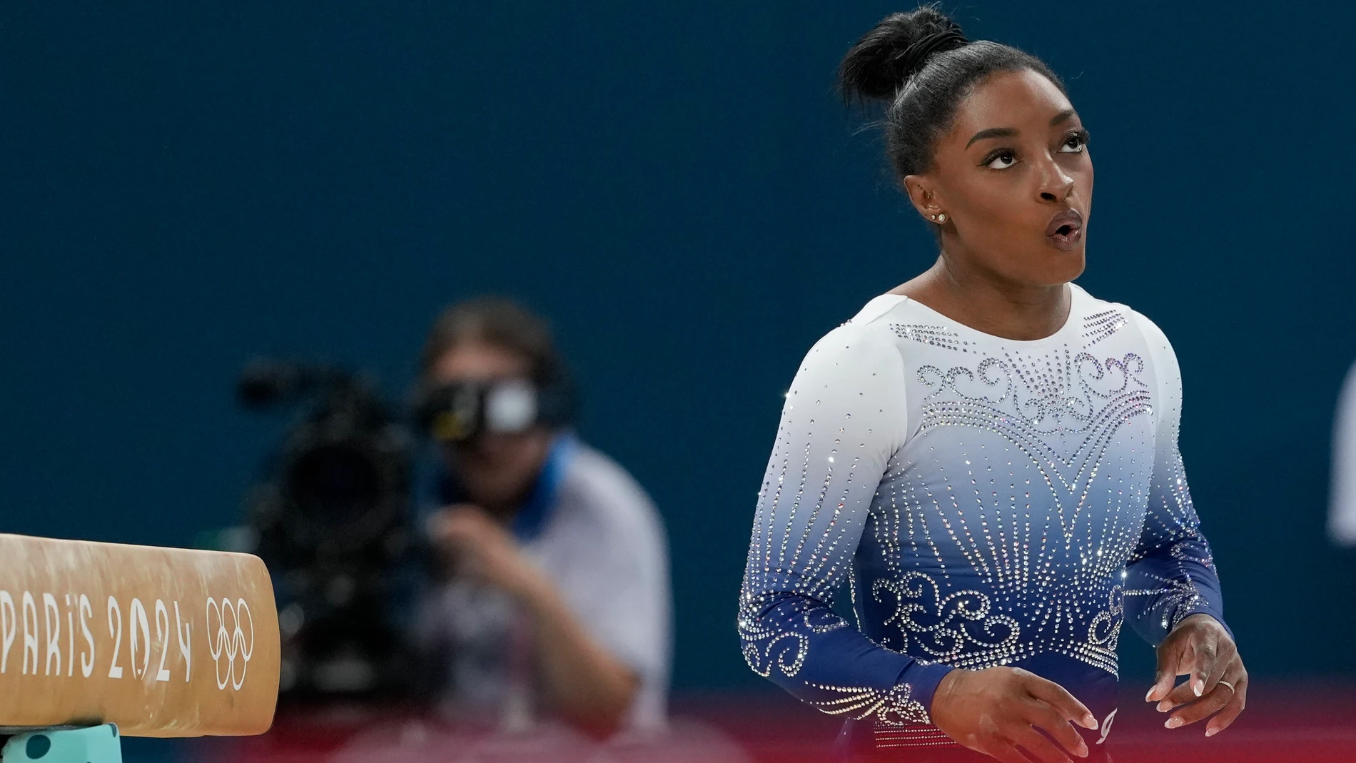 Simone Biles, of the United States, reacts after falling while competing during the women's artistic gymnastics individual balance beam finals at Bercy Arena at the 2024 Summer Olympics, Monday, Aug. 5, 2024, in Paris, France. (AP Photo/Charlie Riedel)
