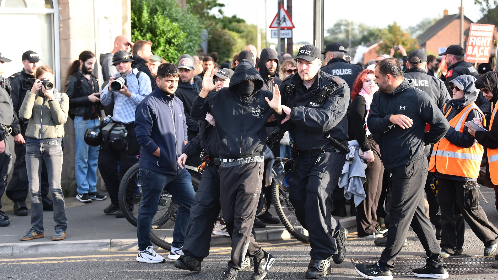 Liverpool (United Kingdom), 06/08/2024.- Police remove a protester who refused to remove their face mask outside the Merseyside Refugee Centre in Liverpool, Britain, 07 August 2024. Further far-right protests are expected throughout Britain on the 07 August 2024. Violent demonstrations have been held by members of far-right groups across Britain following a fatal stabbing attack in Southport, in which three children were killed and eight more seriously injured, along with two adults. (Protest...