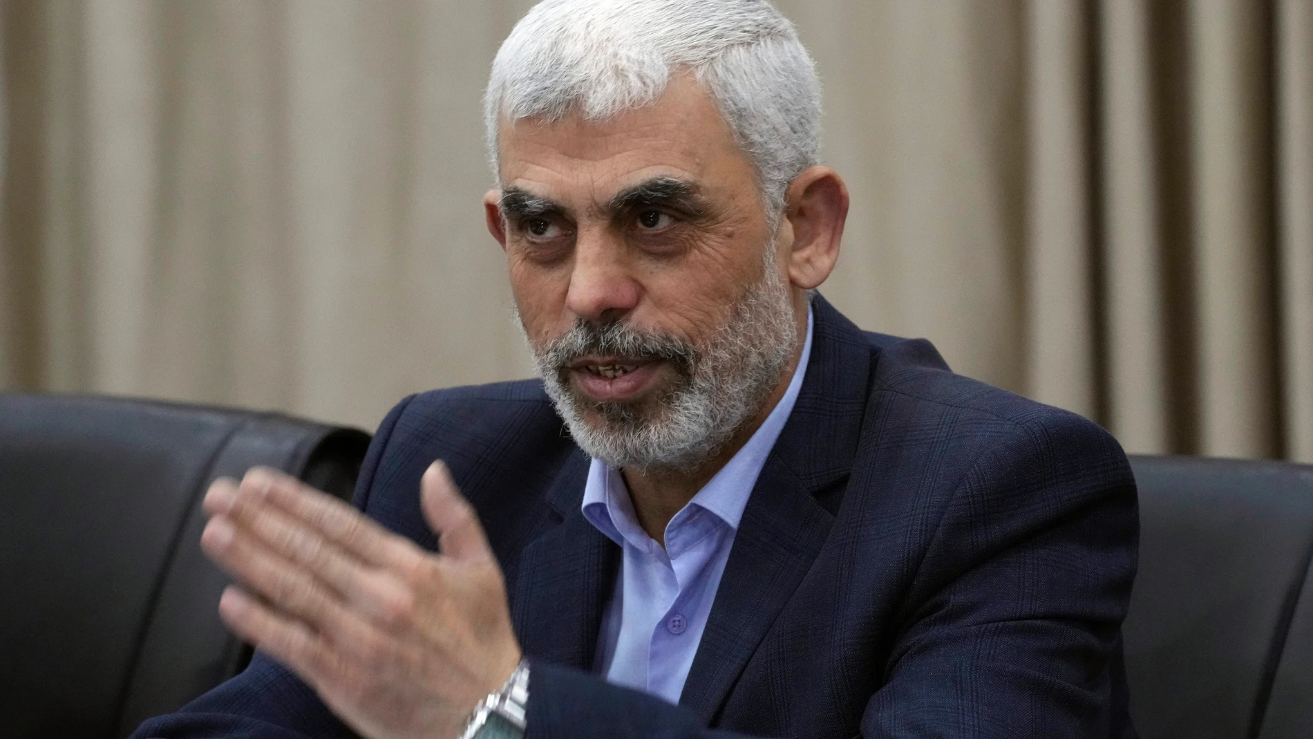 Yahya Sinwar, head of Hamas in Gaza, greets his supporters during a meeting with leaders of Palestinian factions at his office in Gaza City, Wednesday, April 13, 2022. (AP Photo/Adel Hana)