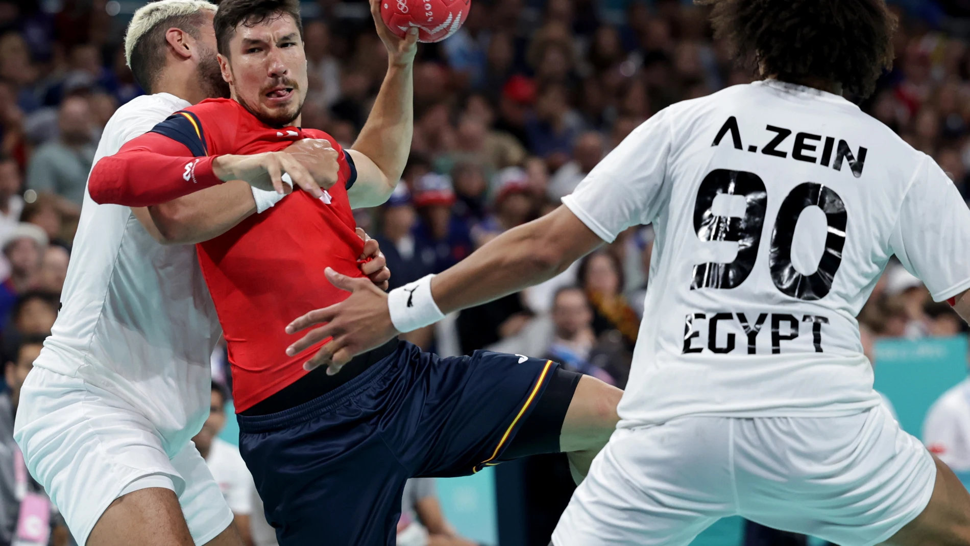 Villeneuve-d'ascq (France), 07/08/2024.- Alex Dujshebaev (C) of Spain in action against Ali Zein (R) of Egypt during the Handball competitions in the Paris 2024 Olympic Games, at the Pierre Mauroy Stadium in Villeneuve-d'Ascq, France, 07 August, 2024. (Balonmano, Egipto, Francia, España) EFE/EPA/ALEX PLAVEVSKI