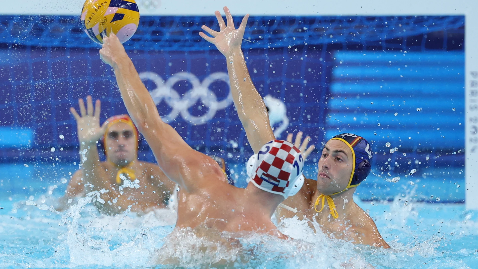 NANTERRE, 07/08/2024.- El español Bermat Sanahuja (d) lucha por el balón con el croata Konstantin Kharkov (c) durante el partido de waterpolo entre Croacia y España celebrado en el marco de los Juegos Olímpicos París 2024 en Nanterre, Francia. EFE/Juanjo Martin