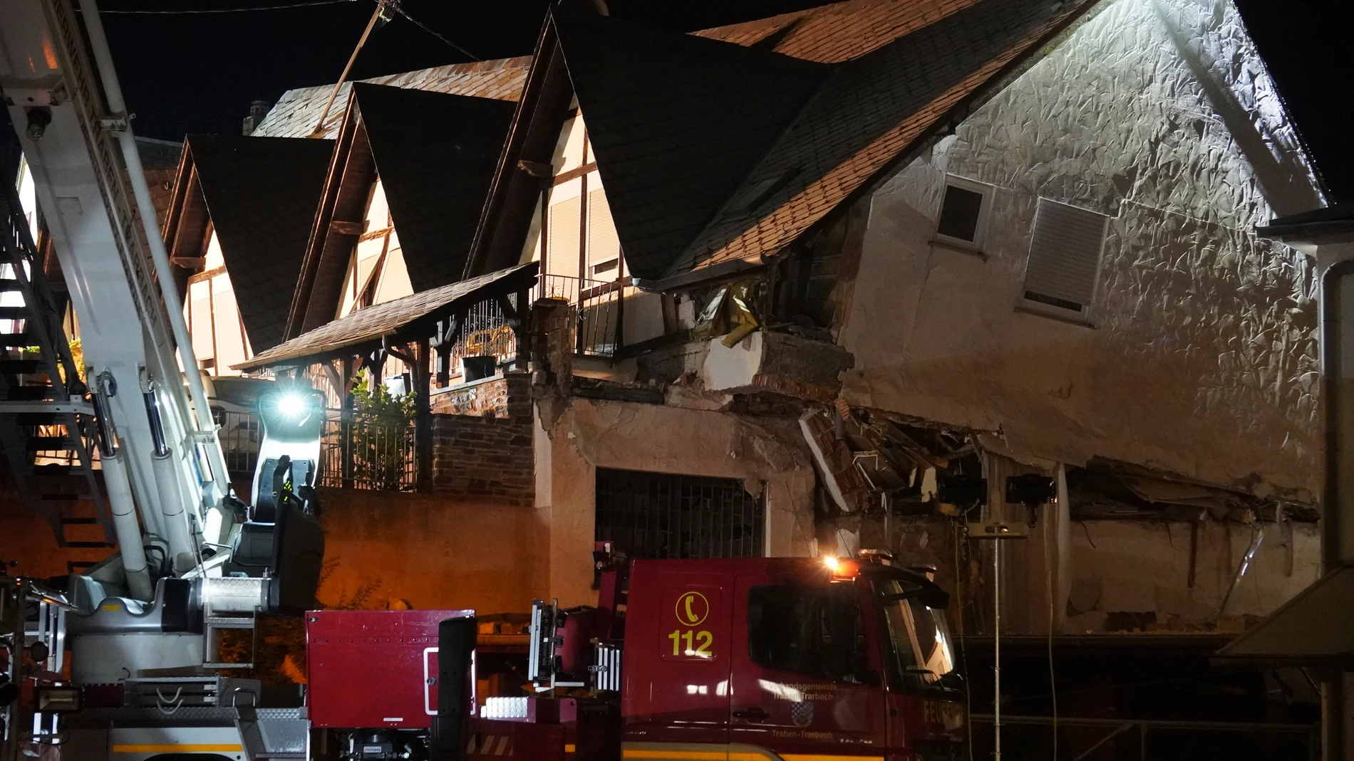 A fire department vehicle stands in front of a collapsed hotel in Kroev, Germany Wednesday, Aug. 7, 2024. (Florian Blaes/dpa via AP)