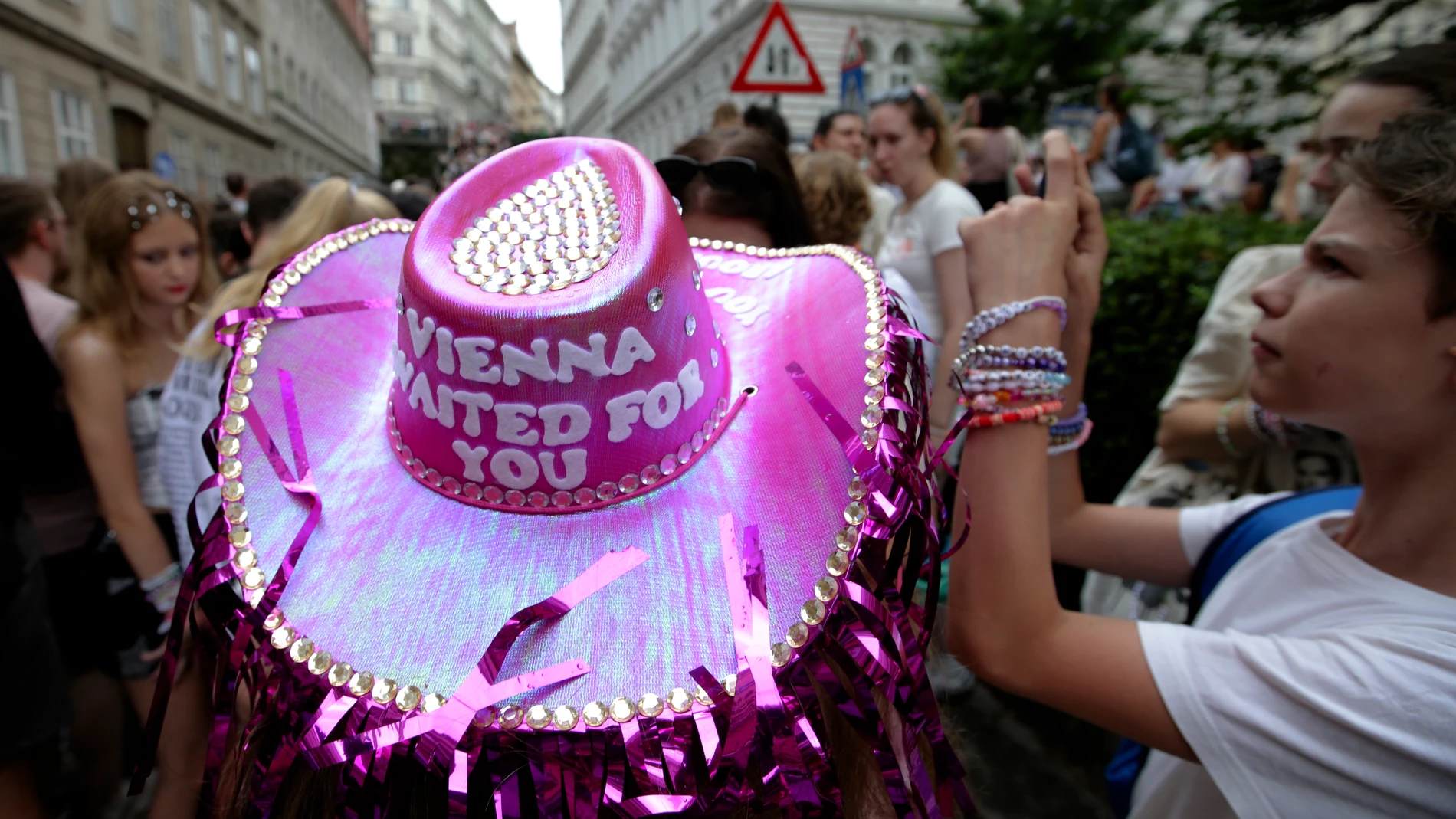A person wears a purple head as Swifties gather in the city centre in Vienna on Thursday, Aug.8, 2024. Organizers of three Taylor Swift concerts in the stadium in Vienna this week called them off on Wednesday after officials announced arrests over an apparent plot to launch an attack on an event in the Vienna area such as the concerts. (AP Photo/Heinz-Peter Bader)