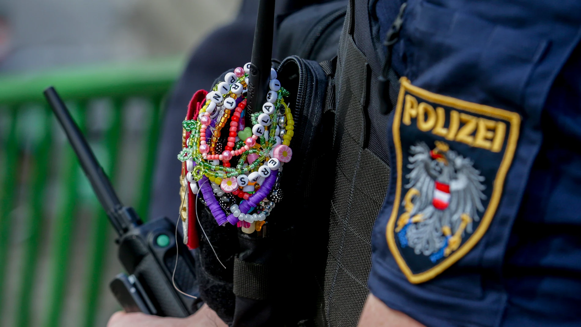 An Austrian police officer is decorated with bracelets in the city centre in Vienna on Thursday, Aug.8, 2024. Organizers of three Taylor Swift concerts in the stadium in Vienna this week called them off on Wednesday after officials announced arrests over an apparent plot to launch an attack on an event in the Vienna area such as the concerts. (AP Photo/Heinz-Peter Bader)