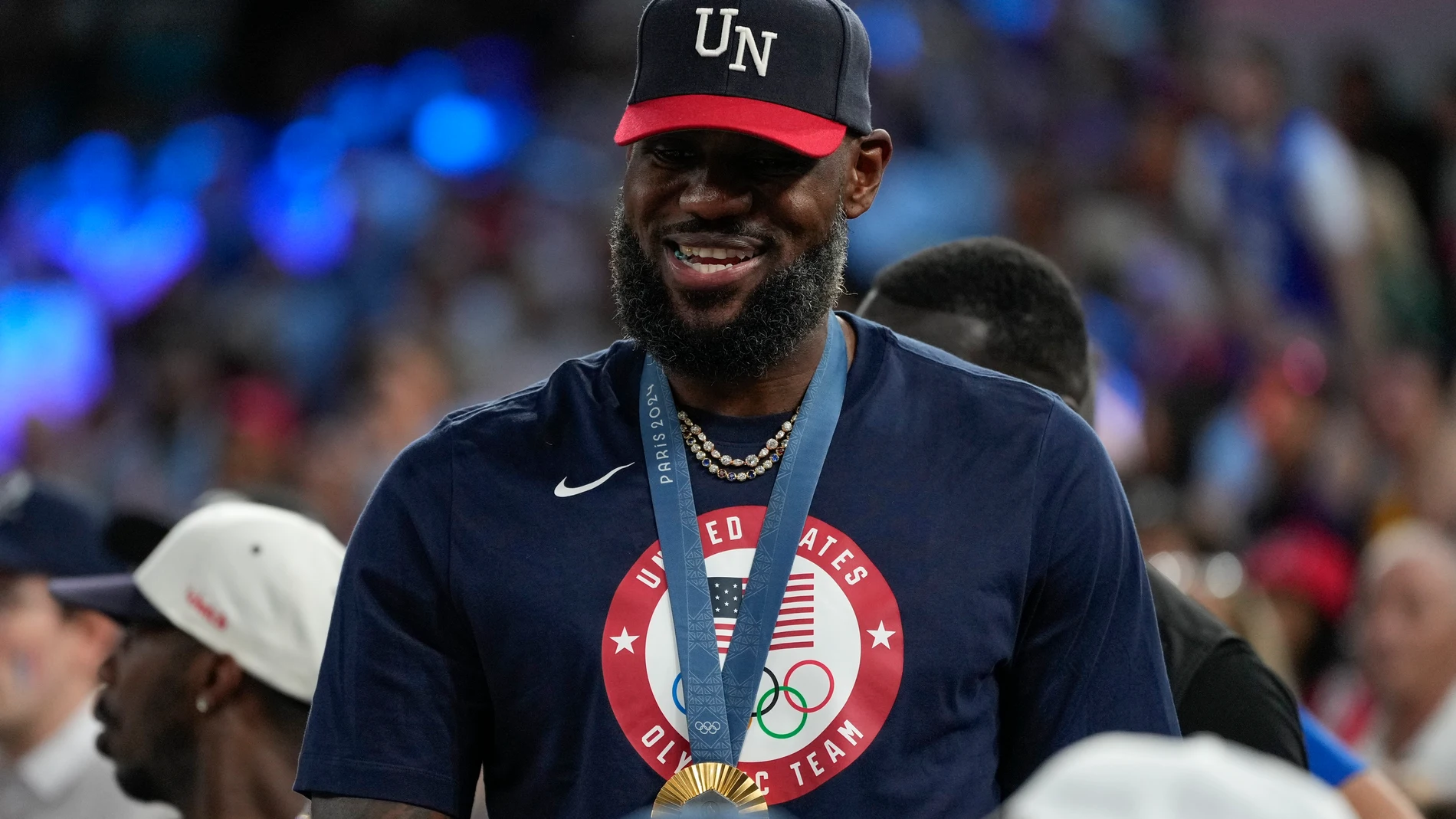 LeBron James wearing his gold medal is seen during a women's gold medal basketball game at Bercy Arena at the 2024 Summer Olympics, Sunday, Aug. 11, 2024, in Paris, France. (AP Photo/Michael Conroy)