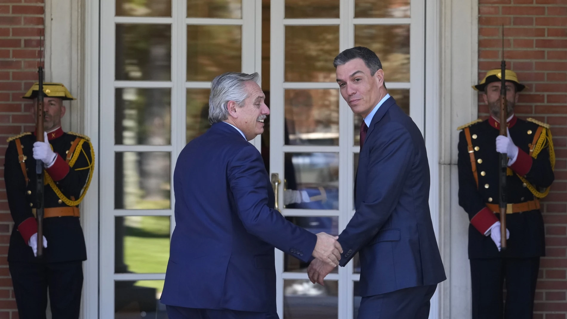 Argentina's President Alberto Fernandez, left and Spain's Prime Minister Pedro Sanchez walk into the Moncloa Palace for a meeting in Madrid, Spain, Tuesday, May 10, 2022.