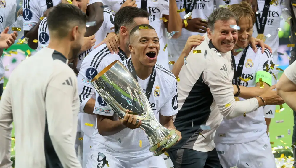 Real Madrid's Kylian Mbappe lifts the trophy as they celebrate winning the UEFA Super Cup soccer match between Real Madrid and Atalanta BC, in Warsaw, Poland, 14 August 2024.
