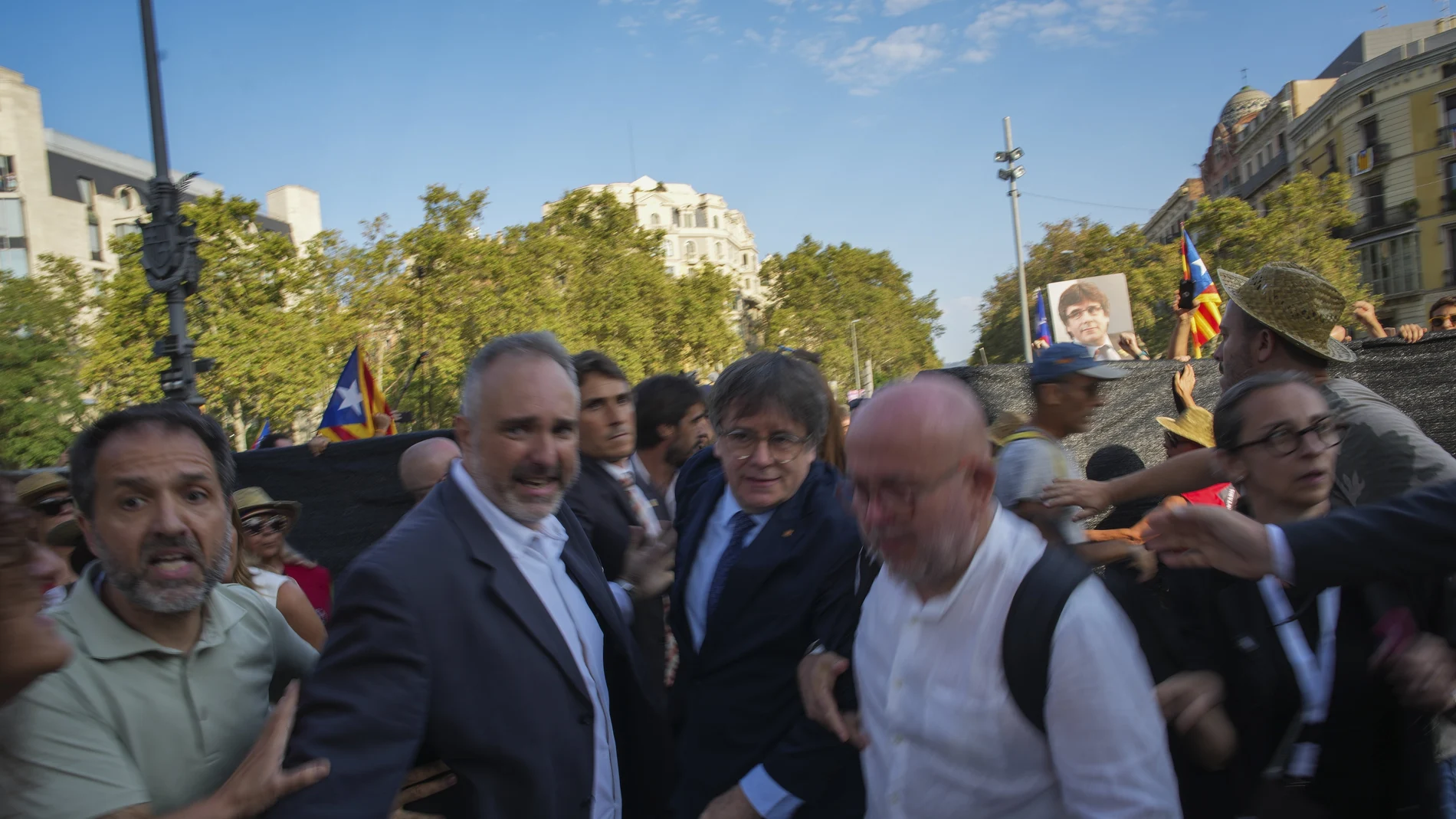 Catalan independence leader and former President Carles Puigdemont, center, arrives to address supporters and to attend the investiture debate near the Catalan parliament in Barcelona, Spain, Thursday Aug. 8, 2024.