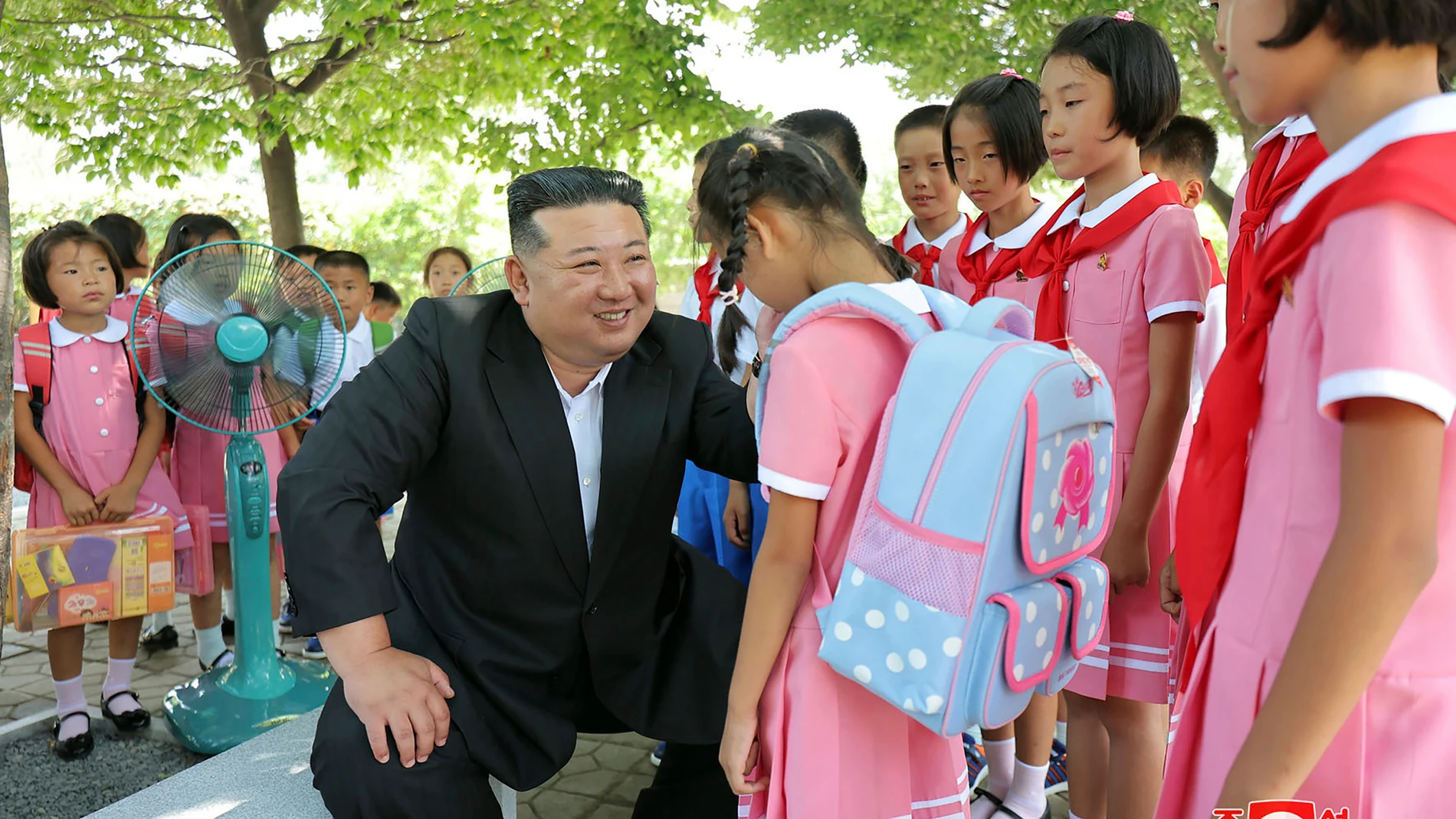 This photo photo provided by the North Korean government, North Korean leader Kim Jong Un, center, meets children who have evacuated from the flooded areas, at a hotel where they are staying in Pyongyang, North Korea, Friday, Aug. 16, 2024. Independent journalists were not given access to cover the event depicted in this image distributed by the North Korean government. The content of this image is as provided and cannot be independently verified. Korean language watermark on image as provide...