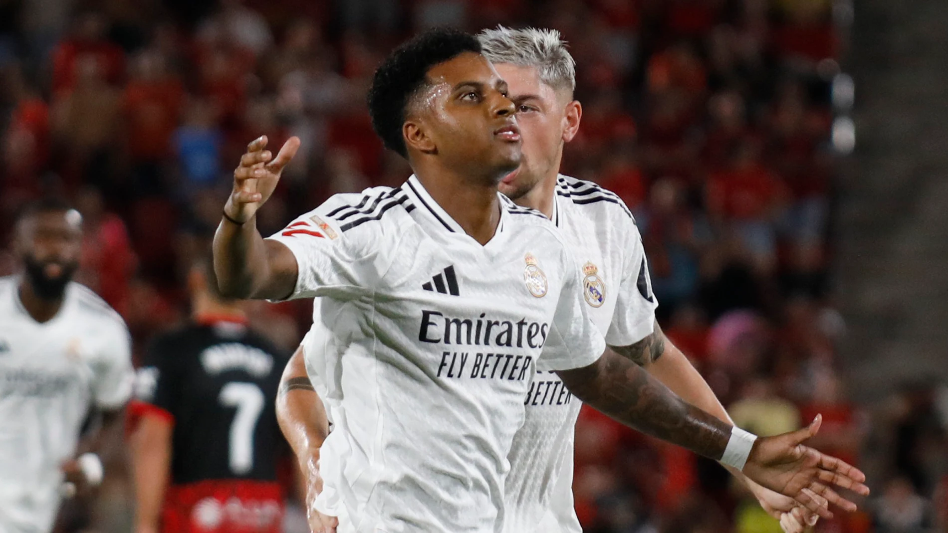 Real Madrid's Rodrygo, front, celebrates with Federico Valverde after scoring the opening goal during a Spanish La Liga soccer match between Mallorca and Real Madrid at the Son Moix Stadium in Palma de Mallorca, Spain, Sunday, Aug. 18, 2024. (AP Photo/Francisco Ubilla)