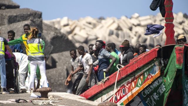 Migrants disembark from a wooden boat at the port in La Restinga on the Canary island of El Hierro, Spain, Sunday, Aug. 18, 2024. Emergency services on Spain's Canary Islands say 175 migrants have arrived in a boat on the Canary Island of El Hierro on Sunday, after a seven-day sailing from the coast of Senegal. (AP Photo/Maria Ximena)