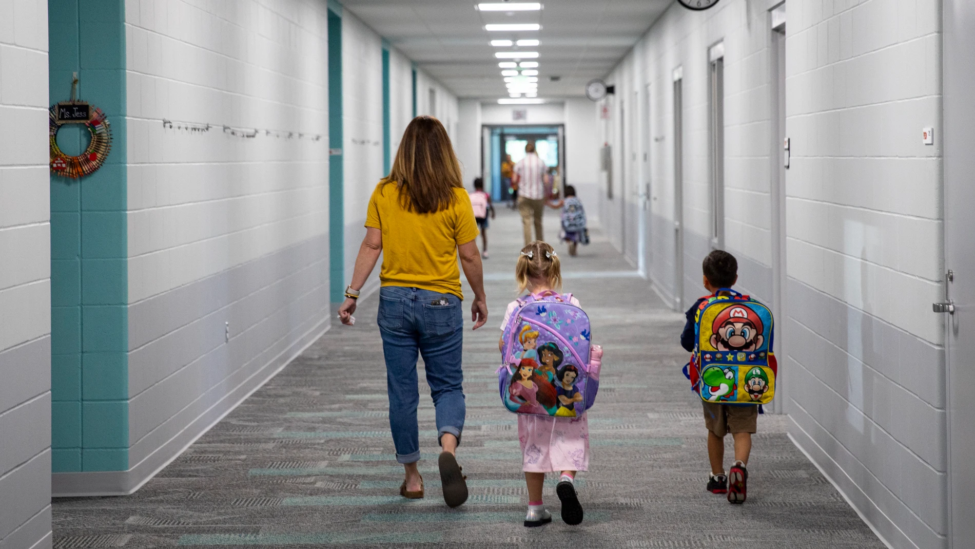 Staff walk students to their classrooms during the first day of school at Parkview Elementary School in Marion, Iowa on Friday, Aug.23, 2024. (Nick Rohlman/The Gazette via AP)