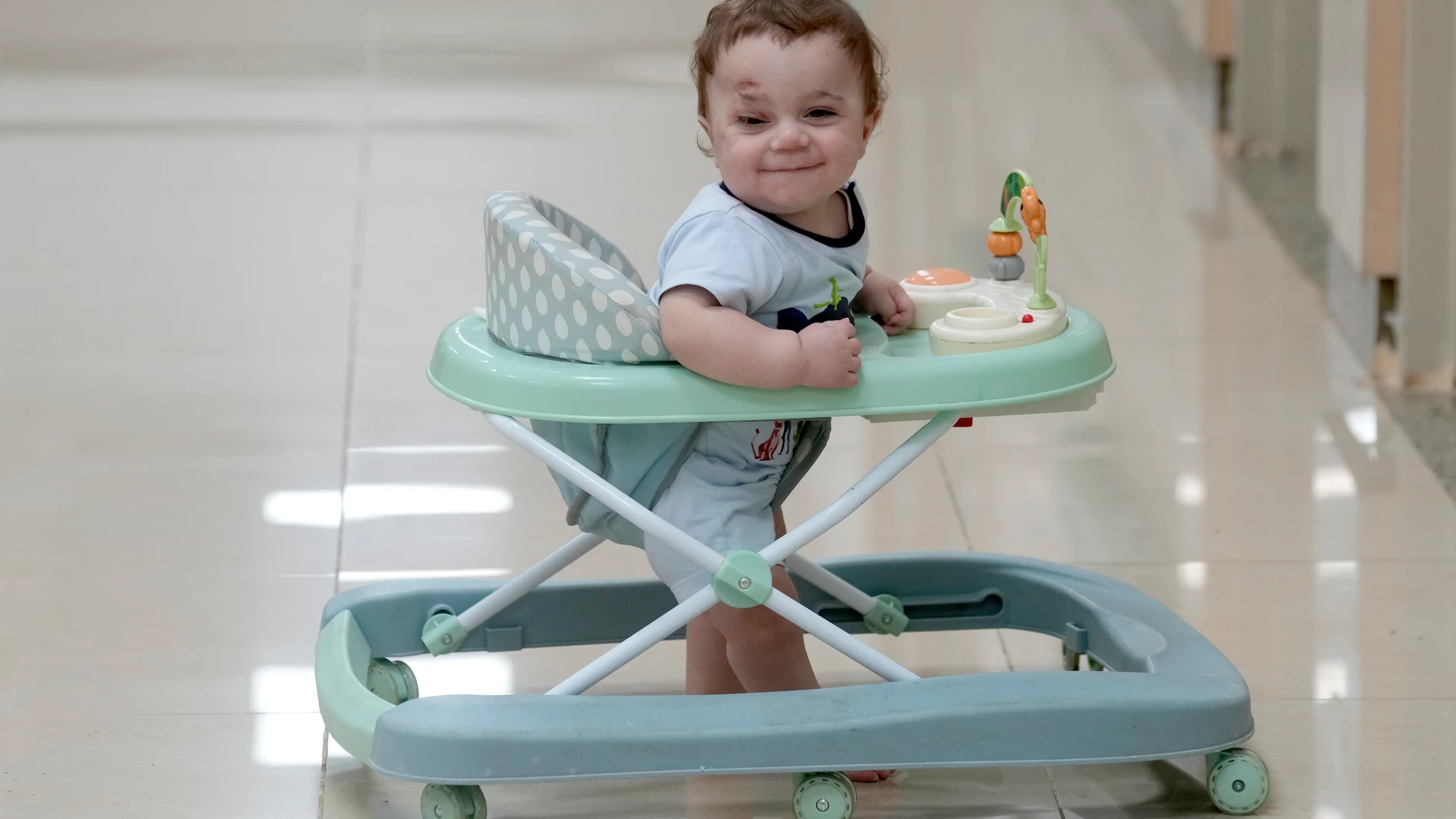 In this Aug. 14, 2024 photo, ten-month-old Palestinian infant Mostafa Qadoura, who has already lost his eye and his immediate family to the horrors of Israel's war against Hamas in Gaza, plays at the New Administrative Capital Hospital, just outside Cairo, Egypt. Mostafa was among the 28 babies, most of whom were born premature, who were evacuated from the then-besieged Shifa Hospital in Gaza City and transported to Egypt late last year. (AP Photo/Amr Nabil)