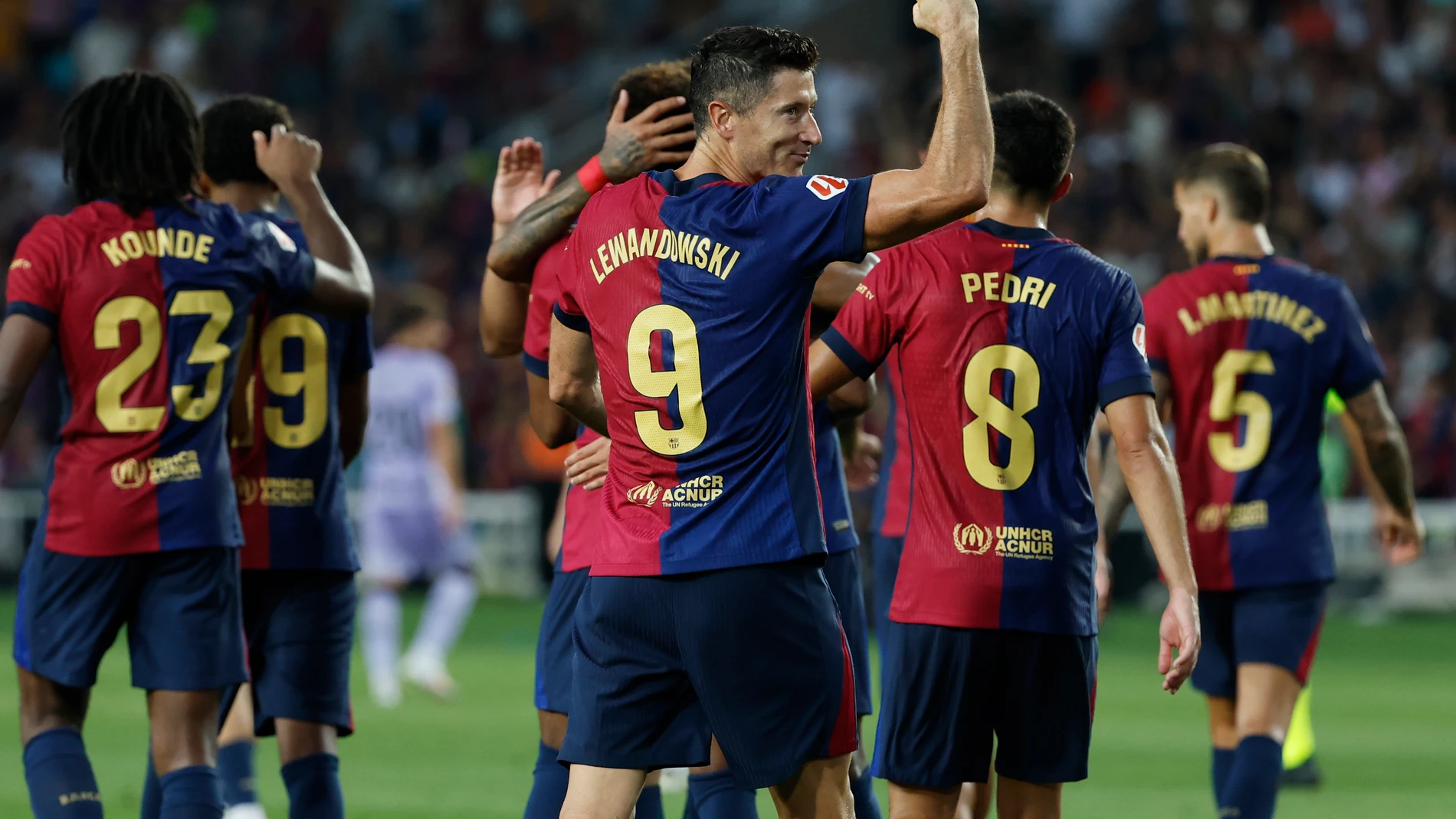 Barcelona's Robert Lewandowski, centre, celebrates with teammates after scoring his side's second goal during the Spanish La Liga soccer match between FC Barcelona and Athletic Bilbao at the Olympic stadium in Barcelona, Spain, Saturday, Aug. 24, 2024. (AP Photo/Joan Monfort)