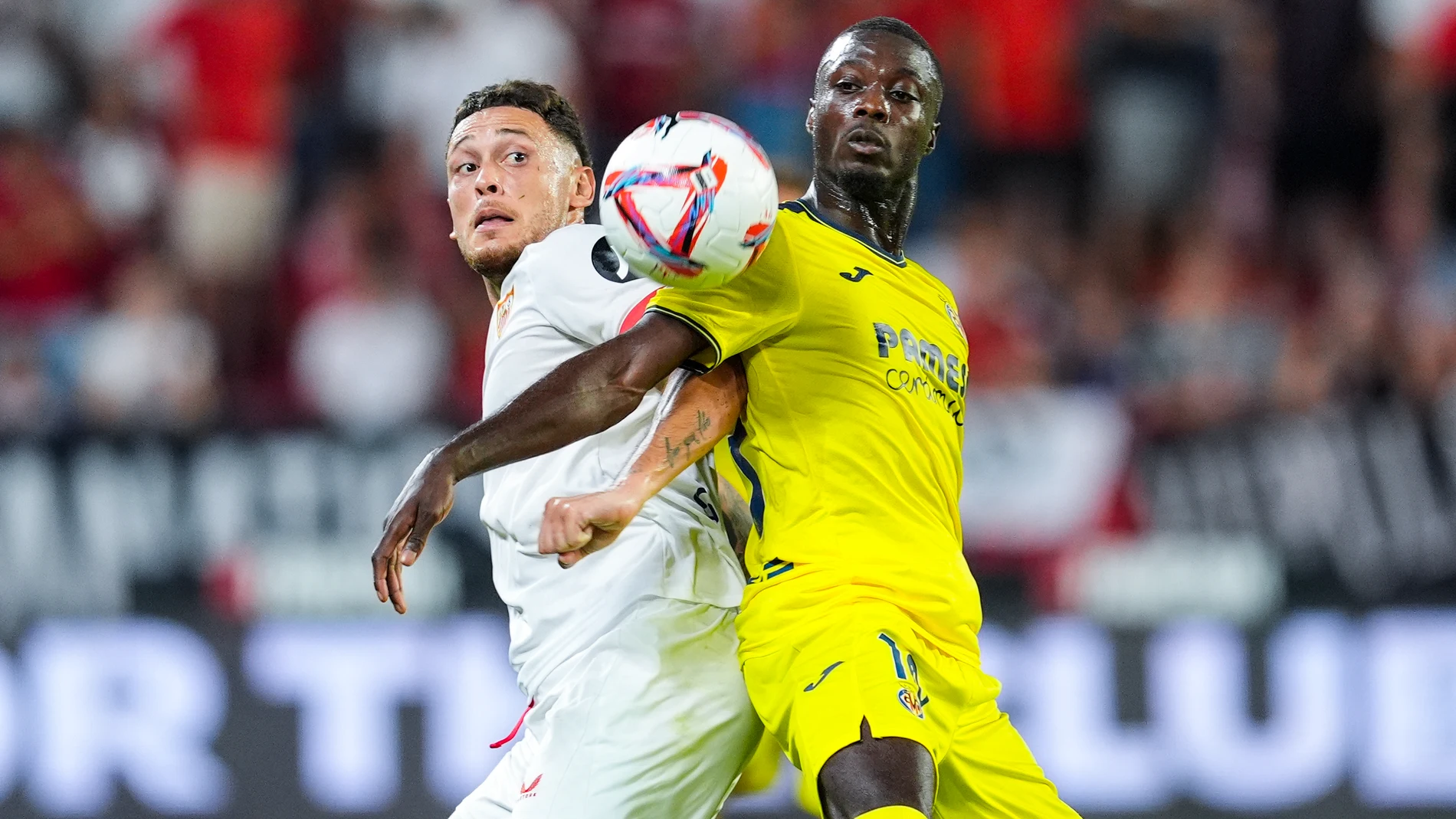 Lucas Ocampos of Sevilla FC and Nicolas Pepe of Villarreal CF in action during the Spanish league, La Liga EA Sports, football match played between Sevilla FC and Villarreal CF at Ramon Sanchez-Pizjuan stadium on August 23, 2024, in Sevilla, Spain. AFP7 23/08/2024 ONLY FOR USE IN SPAIN