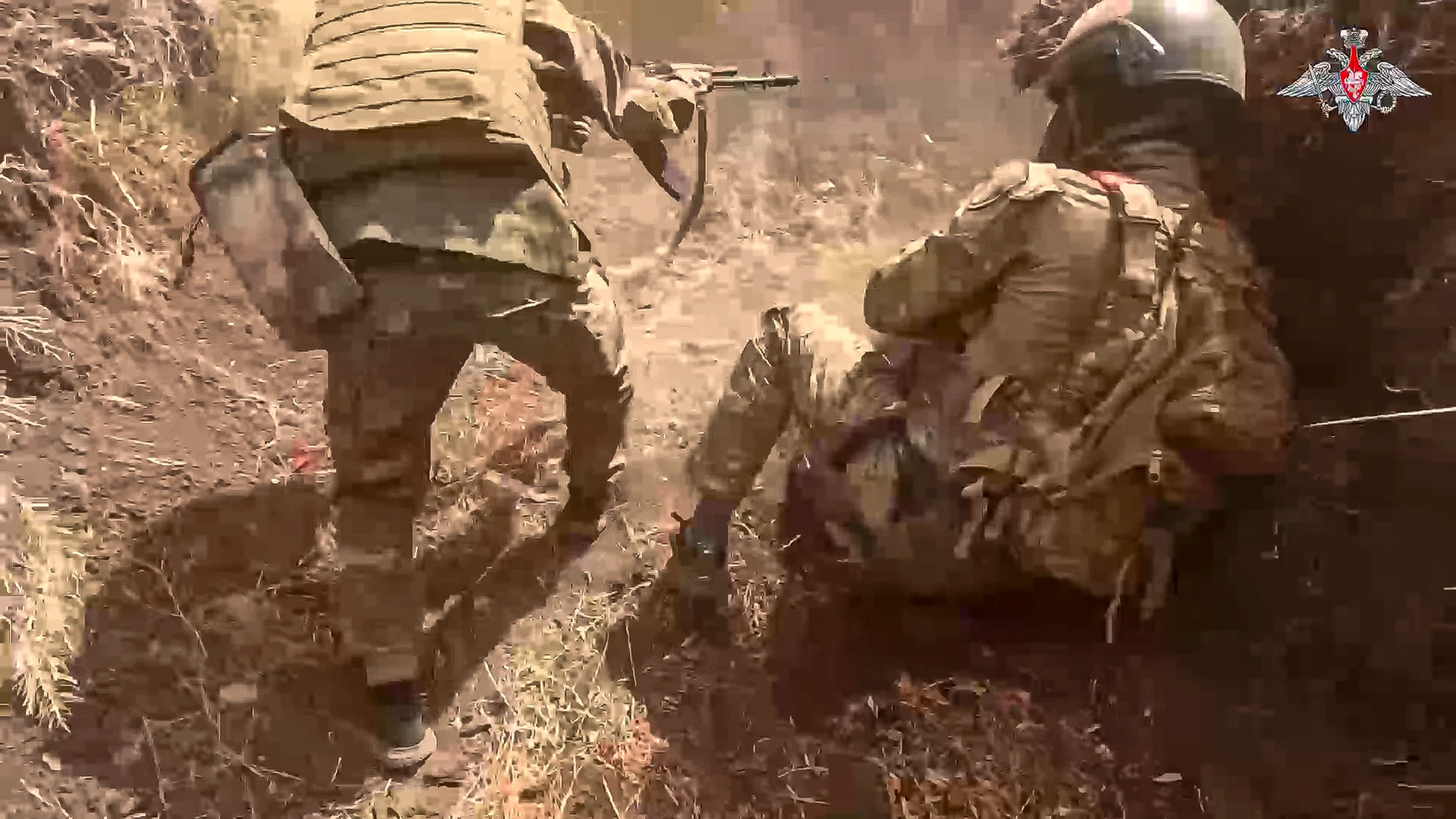 On this photo taken from video released by the Russian Defense Ministry on Monday, Aug. 26, 2024, A Russian assault unit fight to take a Ukrainian position in the direction of Konstantinovka in Ukraine. (Russian Defense Ministry Press Service via AP)