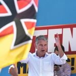 AfD top candidate Björn Höcke speaks at an AfD election rally behind a German flag with the Iron Cross. State elections will be held in Thuringia on September 1.
