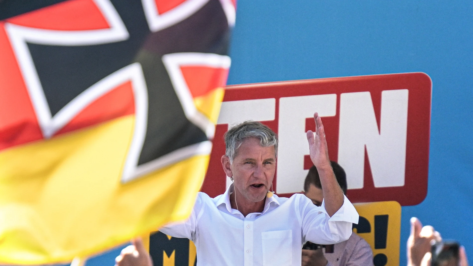 AfD top candidate Björn Höcke speaks at an AfD election rally behind a German flag with the Iron Cross. State elections will be held in Thuringia on September 1.