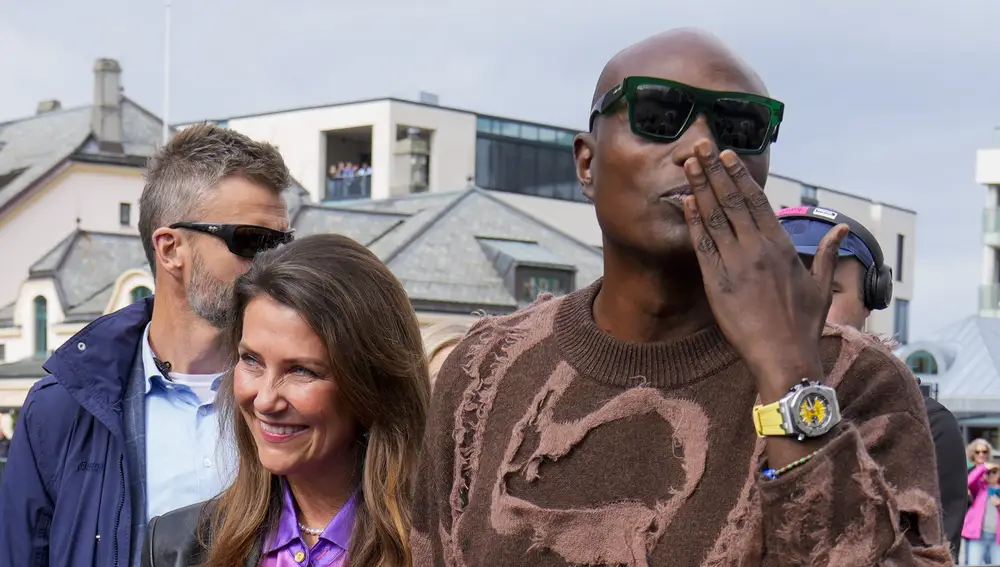 Norwegian Princess Martha Louise (C) and her partner, US businessman Durek Verrett (R) arrive at the boats that will transport them to their wedding celebration, in Alesund, western Norway, 30 August 2024. On 31 August, the Norwegian princess and her partner will get married at Hotel Union in in the village of Geiranger in western Norway.