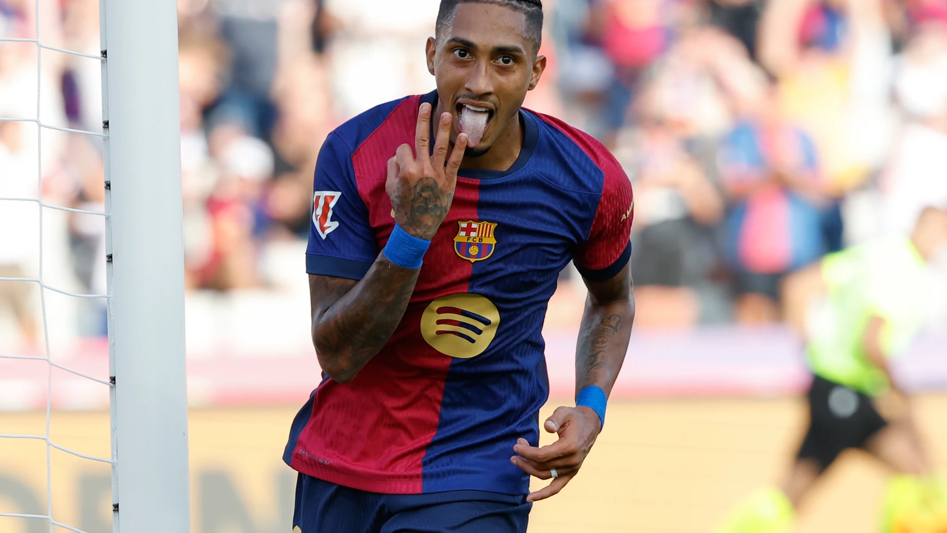 Barcelona's Raphinha celebrates scoring his side's 5th goal during the Spanish La Liga soccer match between FC Barcelona and Valladolid at the Olympic stadium in Barcelona, Spain, Saturday, Aug. 31, 2024. (AP Photo/Joan Monfort)