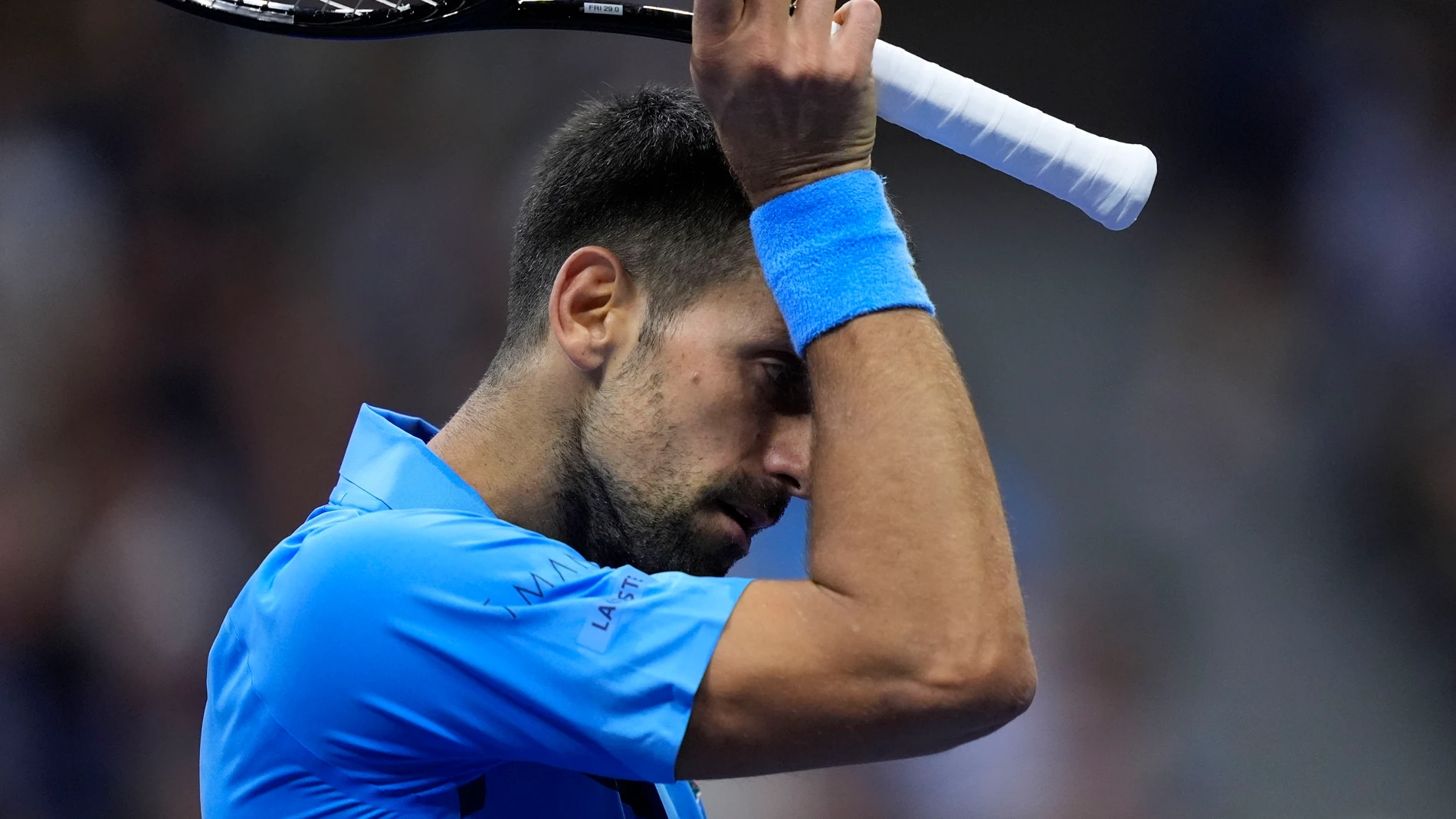Novak Djokovic, of Serbia, wipes his face against =Alexei Popyrin, of Australia, during a third round match of the U.S. Open tennis championships, Friday, Aug. 30, 2024, in New York. (AP Photo/Julia Nikhinson)