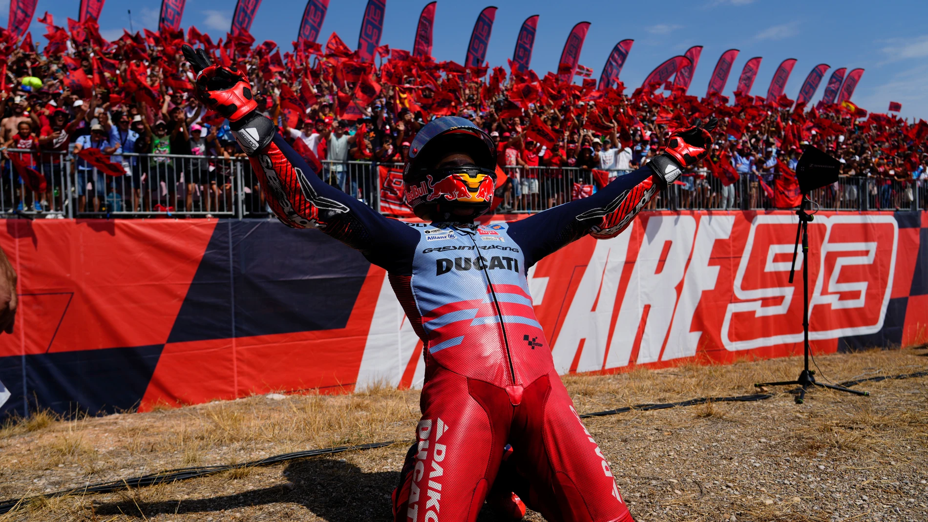 Spain's rider Marc Marquez of the Gresini Racing MotoGP celebrates in front of fans after winning the MotoGP Aragon Motorcycle Grand Prix at the MotorLand Aragon circuit, in Alcaniz, Spain, Sunday, Sept. 1, 2024. (AP Photo/Jose Breton)