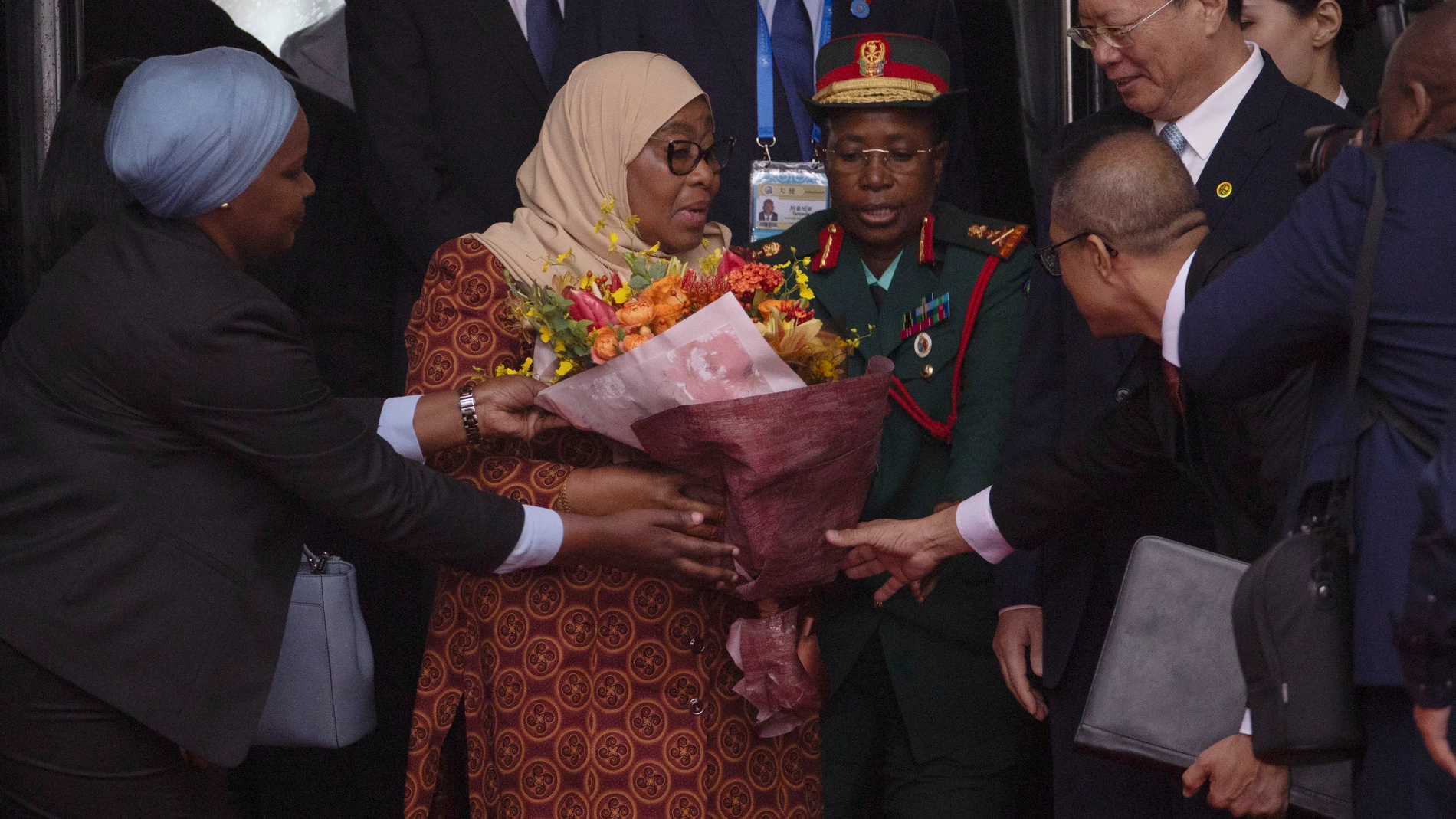 Tanzania's President Samia Suluhu Hassan, center left, receives a bouquet of flowers on her arrival at the Beijing Capital International Airport in Beijing ahead of the Forum on China-Africa Coperation (FOCAC), Tuesday, Sept. 3, 2024. (Andres Martinez Casares /Pool Photo via AP)