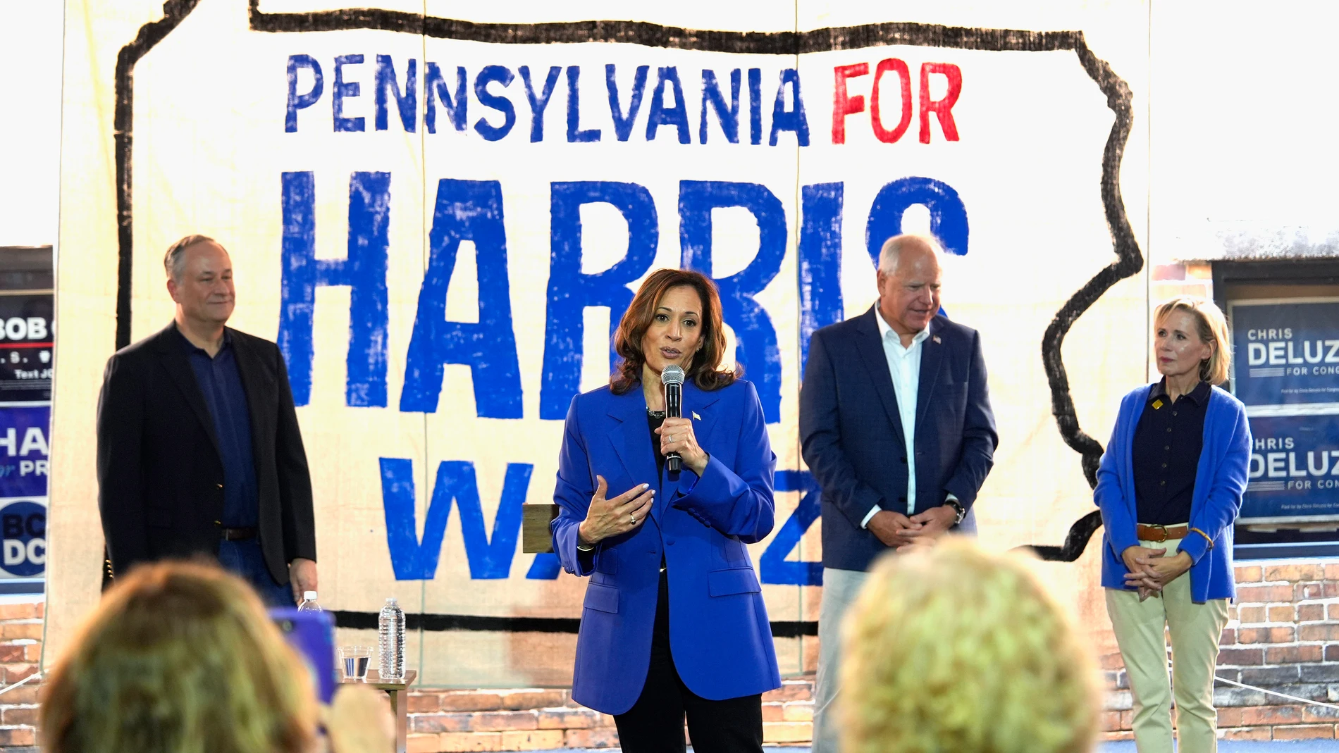 FILE - Democratic presidential nominee Vice President Kamala Harris speaks as second gentleman Doug Emhoff, from left, Democratic vice presidential nominee Minnesota Gov. Tim Walz and his wife Gwen Walz listen at a campaign event, Aug. 18, 2024, in Rochester, Pa. (AP Photo/Julia Nikhinson)