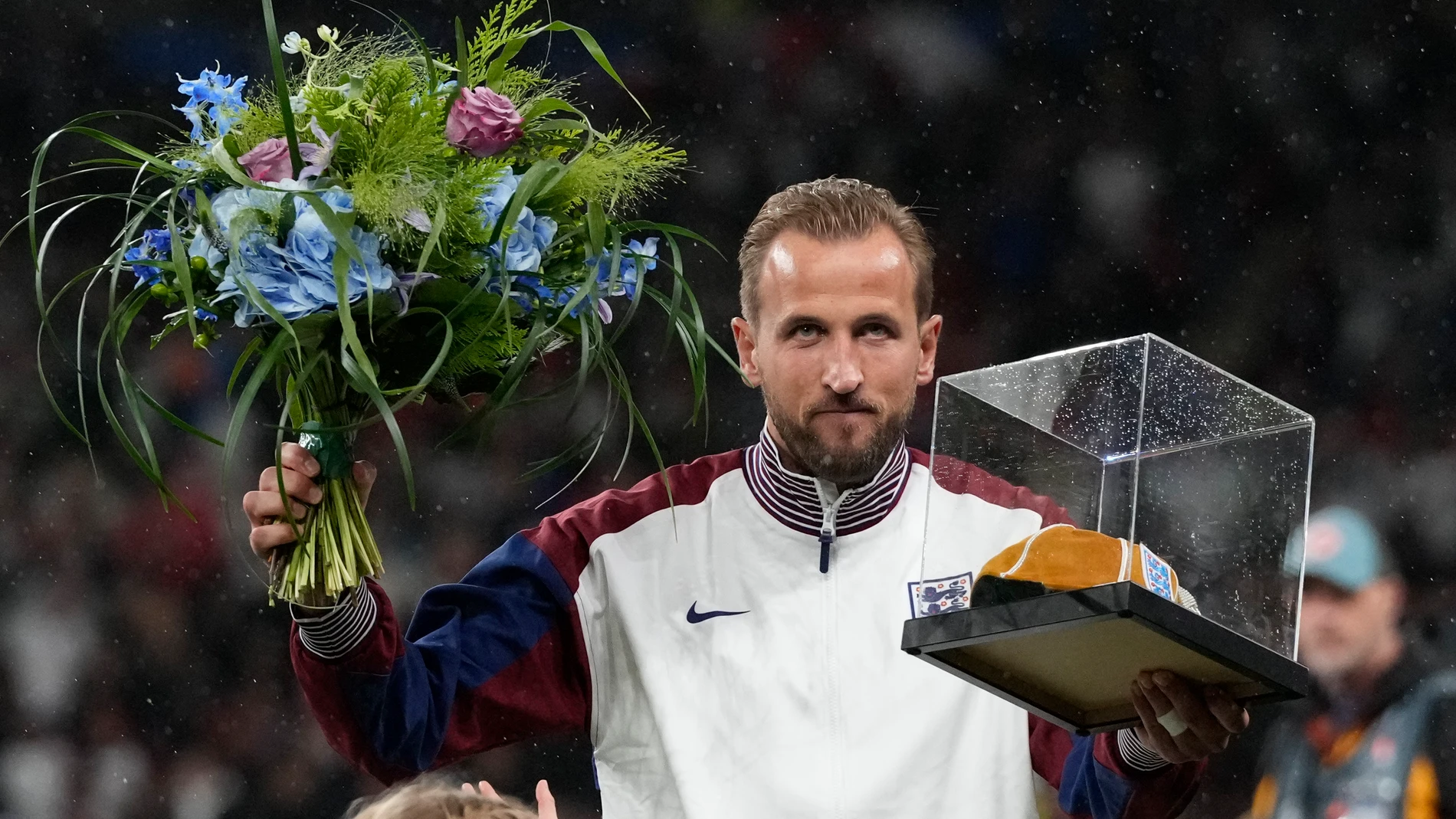 England's Harry Kane poses with award for his hundredth match the Group F UEFA Nations League soccer match between England and Finland at Wembley Stadium in London, Tuesday, Sept. 10, 2024. (AP Photo/Frank Augstein)