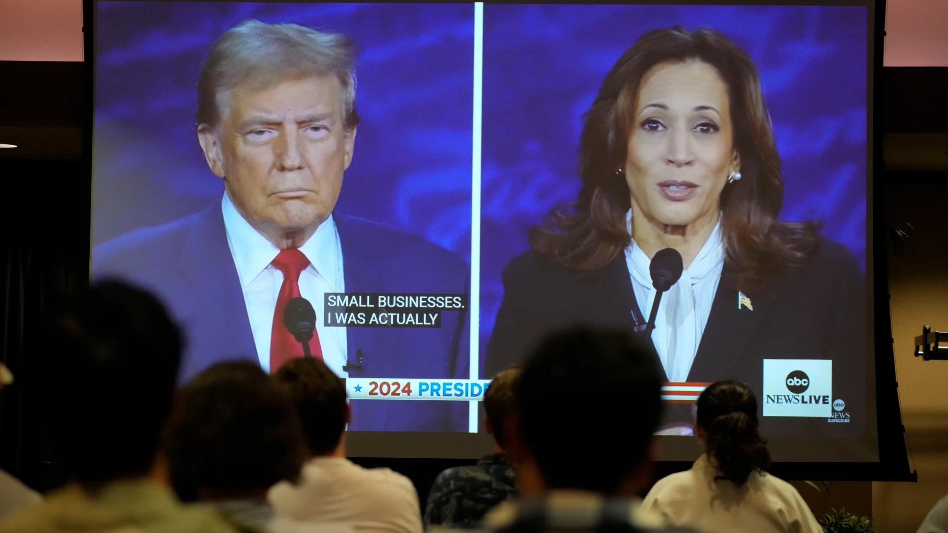Ball State University students watch a presidential debate between Republican presidential nominee former President Donald Trump, left, and Democratic presidential nominee Vice President Kamala Harris, Tuesday, Sept. 10, 2024, in Muncie, Ind. (AP Photo/Darron Cummings)