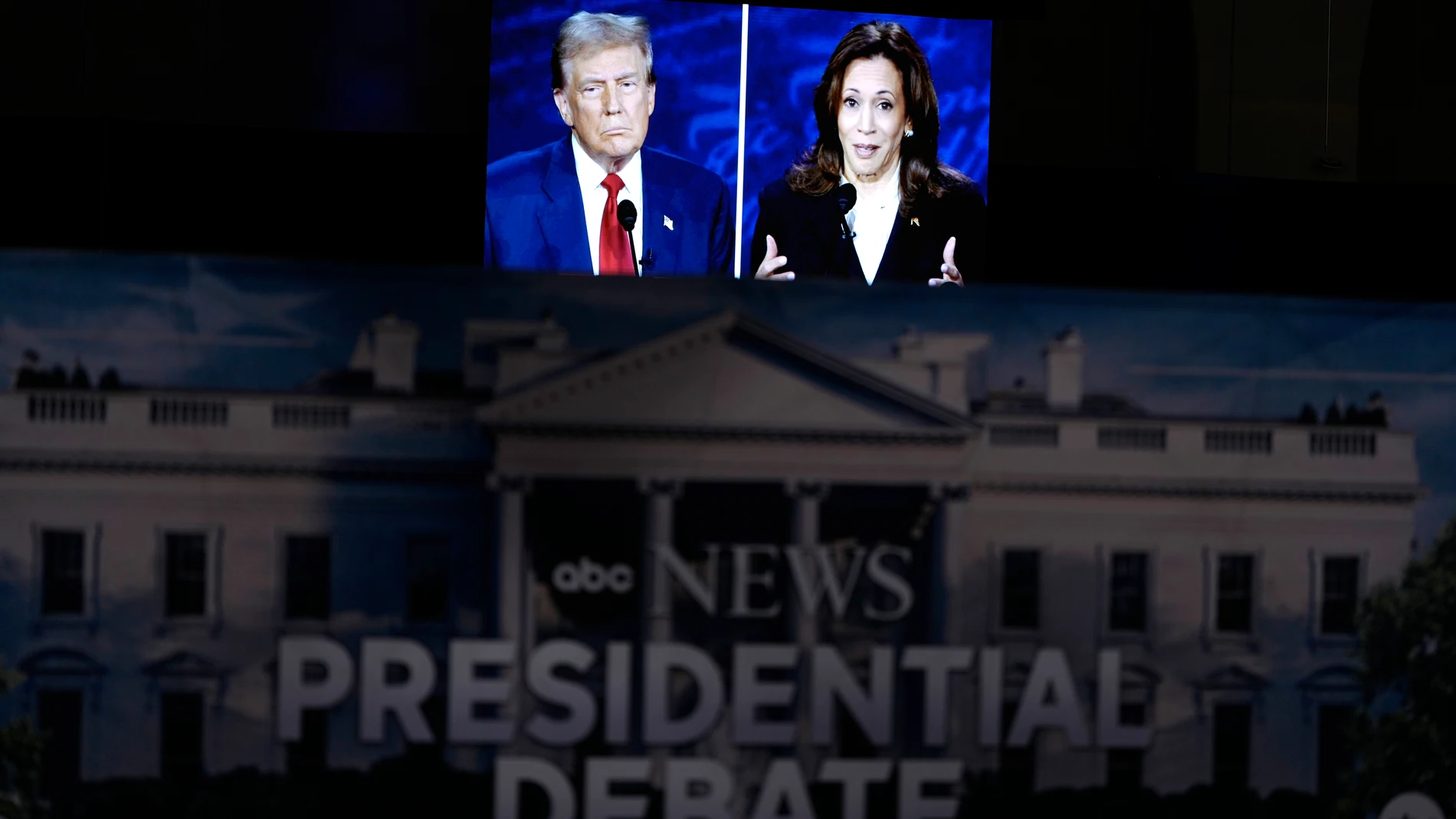 A presidential debate between Republican presidential nominee former President Donald Trump, on screen at left, and Democratic presidential nominee Vice President Kamala Harris, right, is seen from the spin room, Tuesday, Sept. 10, 2024, in Philadelphia. (AP Photo/Matt Slocum)