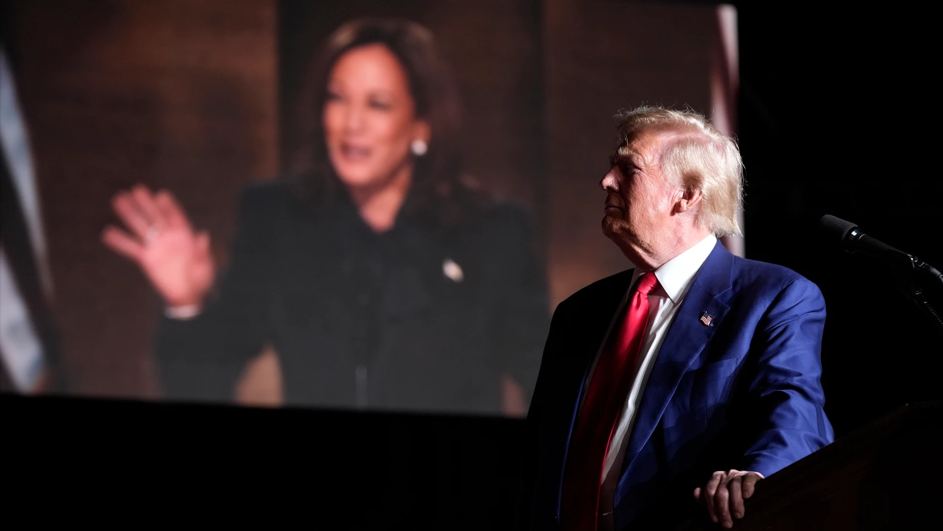 Republican presidential nominee former President Donald Trump speaks as an image of democratic presidential candidate Vice President Kamala Harris appears on screen during a campaign event at the World Market Center, Friday, Sept.13, 2024, in Las Vegas. (AP Photo/Alex Brandon)