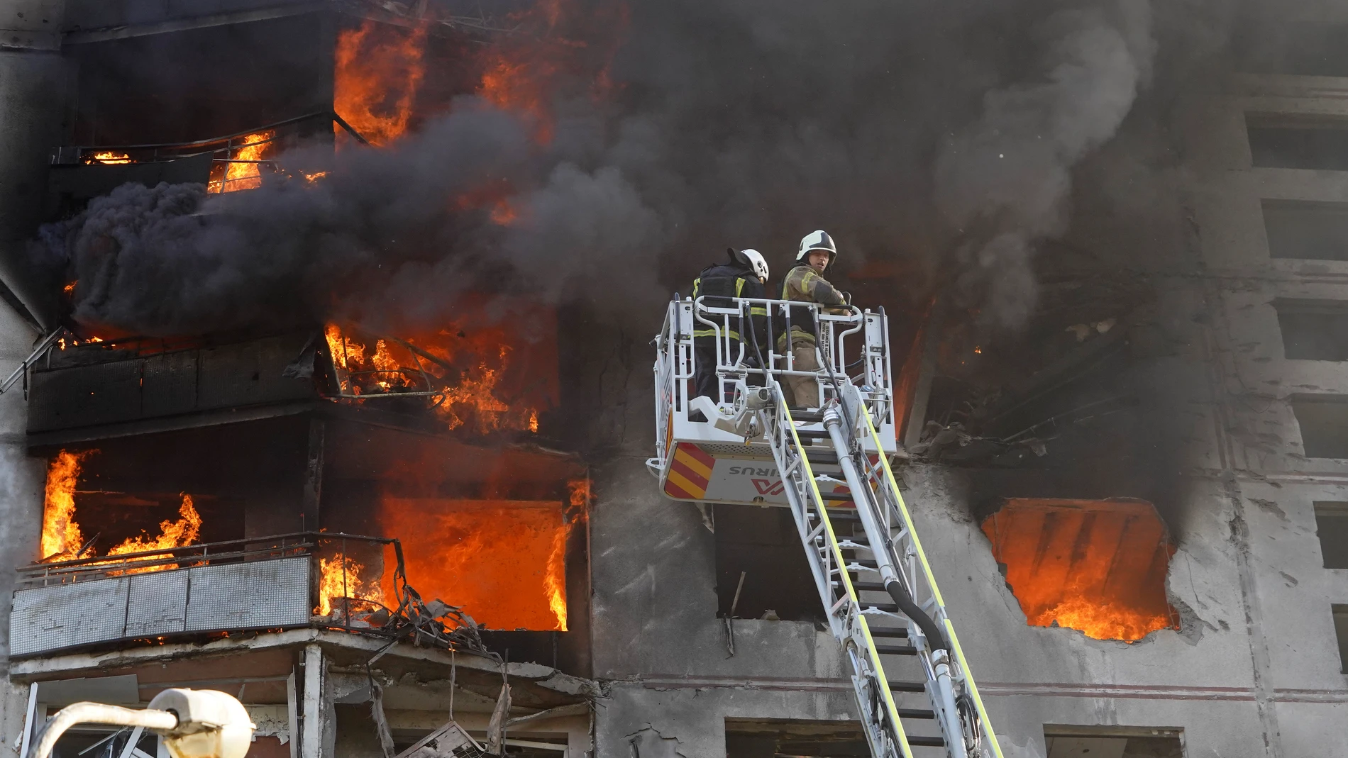Firefighters tackle a blaze after a Russian aerial bomb struck a multi-story residential building in Kharkiv, Ukraine, Sunday Sept. 15, 2024. (AP Photo/Andrii Marienko)