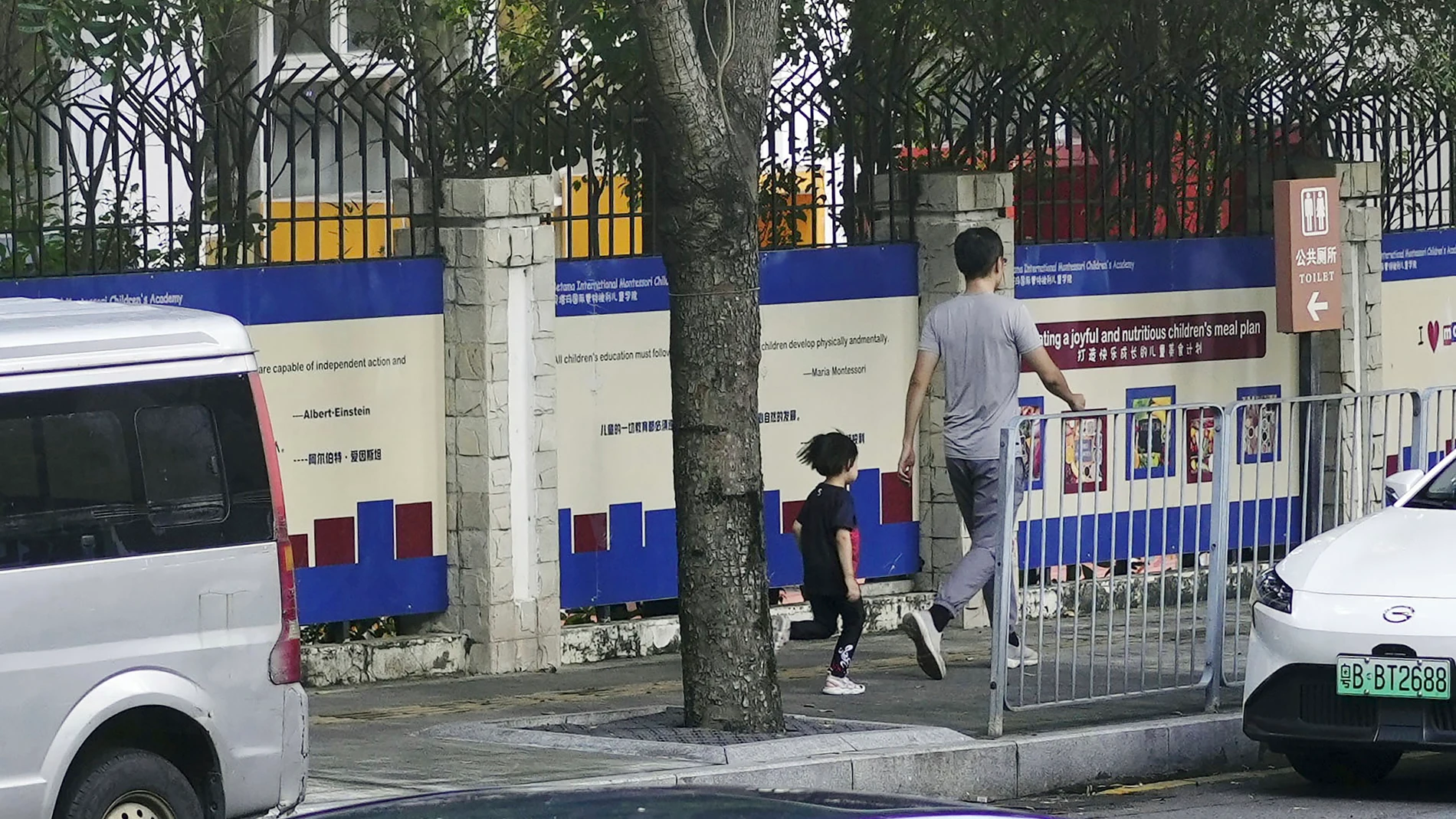 People walk past the Shenzhen Japanese School in Shenzhen, China Wednesday, Sept. 18, 2024, where a 10-year-old Japanese student was stabbed by a man. (Kyodo News via AP)