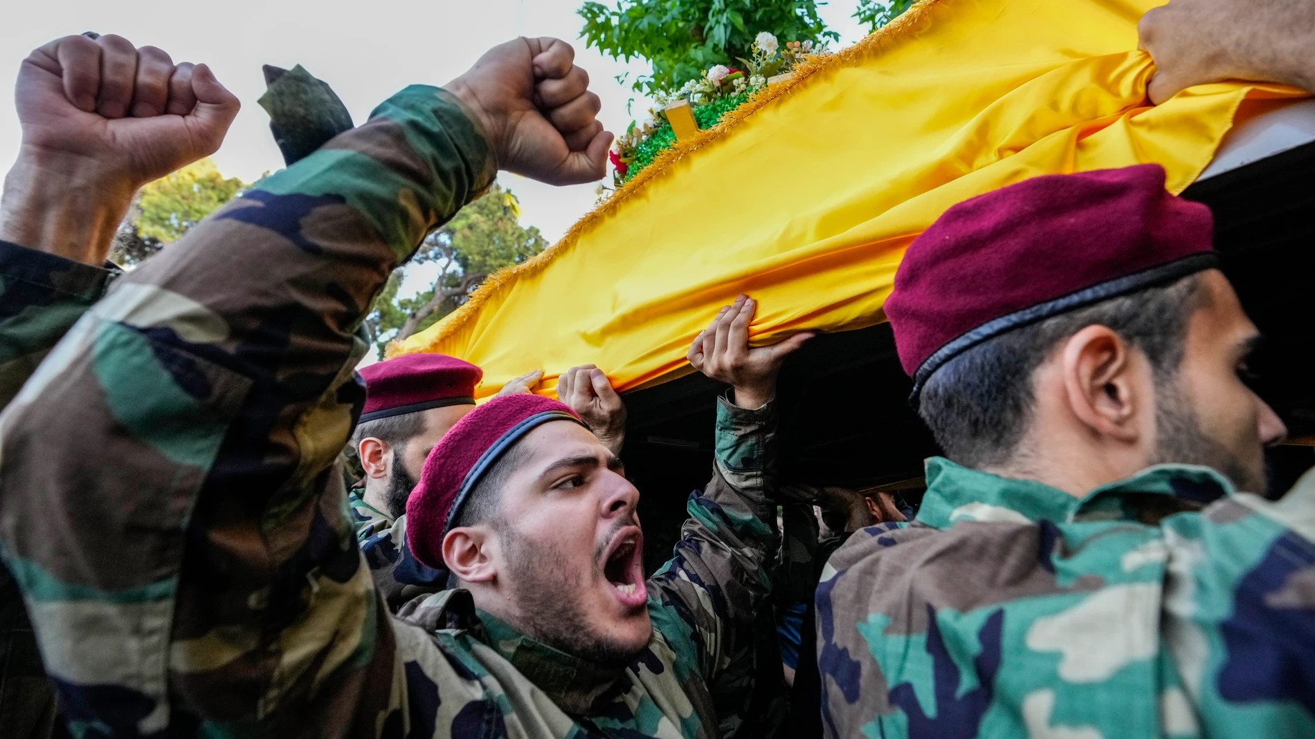 Hezbollah members shout slogans as they carry the coffins of Hezbollah commanders Ibrahim Kobeisi and Hussein Ezzedine during their funeral procession in Beirut's southern suburb, Wednesday, Sept. 25, 2024. (AP Photo/Hassan Ammar)