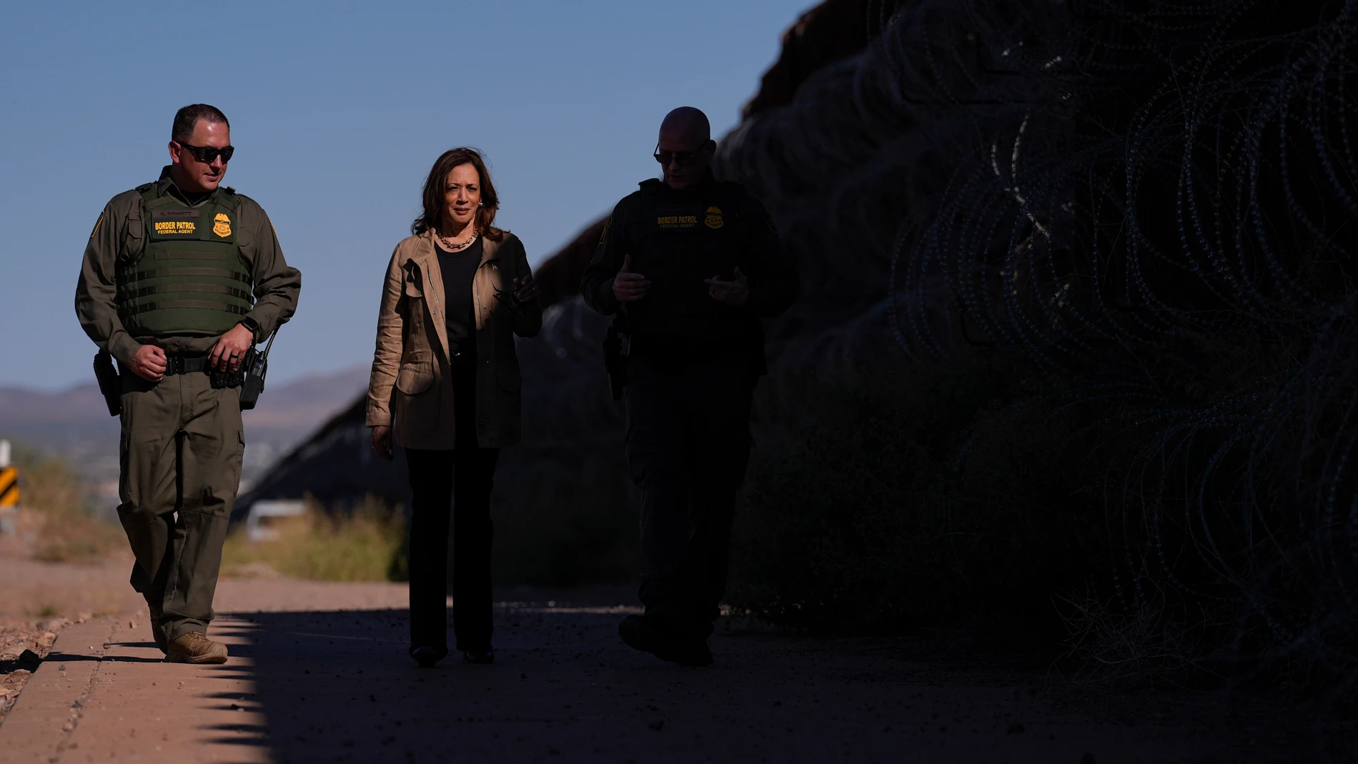 Democratic presidential nominee Vice President Kamala Harris talks with John Modlin, the chief patrol agent for the Tucson Sector of the U.S. Border Patrol, right, and Blaine Bennett, the U.S. Border Patrol Douglas Station border patrol agent in charge, as she visits the U.S. border with Mexico in Douglas, Ariz., Friday, Sept. 27, 2024. (AP Photo/Carolyn Kaster)