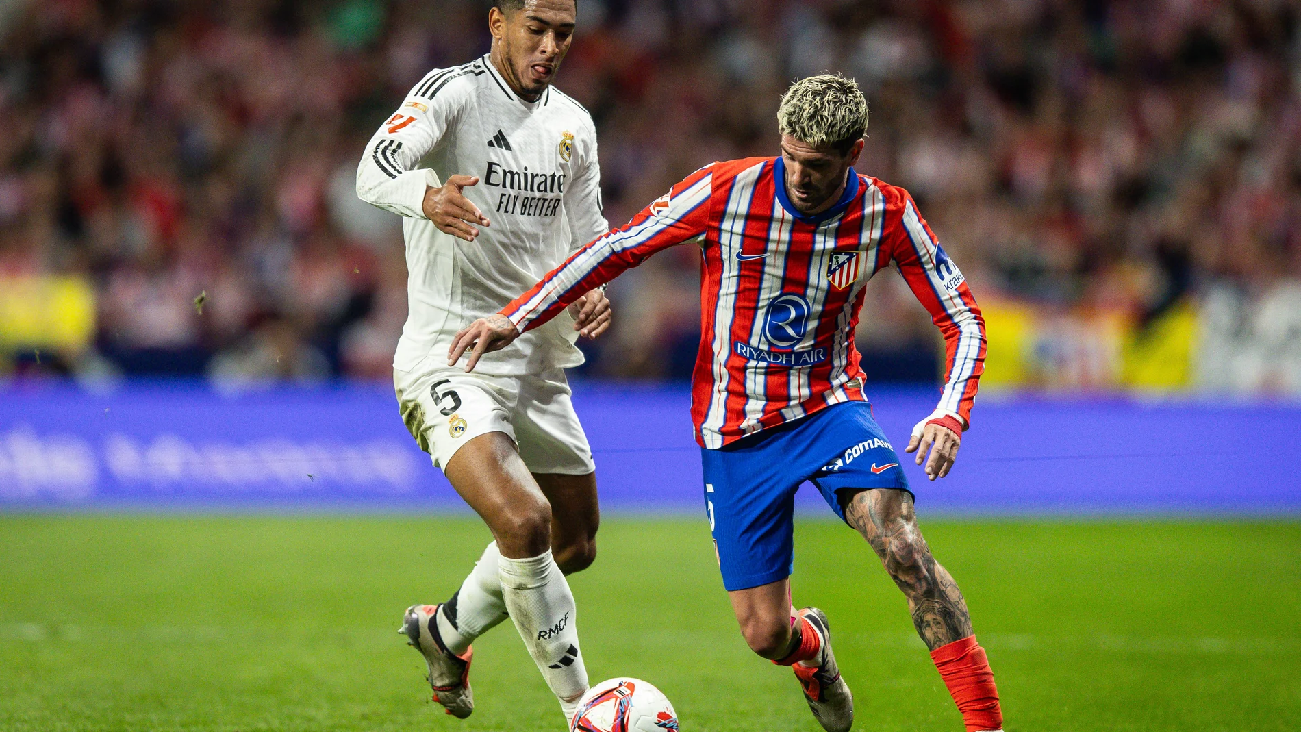29 September 2024, Spain, Madrid: Real Madrid's Jude Bellingham (L) and Atletico's Rodrigo De Paul battle for the ball during the Spanish Division Primera soccer match between Atletico de Madrid and Real Madrid at Civitas Metropolitano Stadium Photo: Matthieu Mirville/ZUMA Press Wire/dpa Matthieu Mirville/ZUMA Press Wir / DPA 29/09/2024 ONLY FOR USE IN SPAIN
