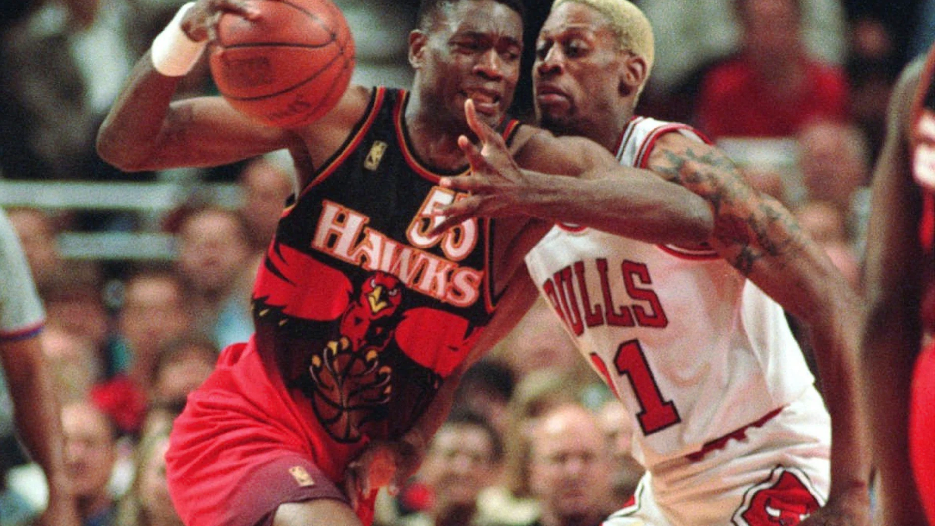 FILE - The Atlanta Hawks' Dikembe Mutombo, left, drives to the hoop against the Chicago Bulls' Dennis Rodman during the second quarter of their playoff game Thursday, May 8, 1997, in Chicago. (AP Photo/Michael S. Green, File)