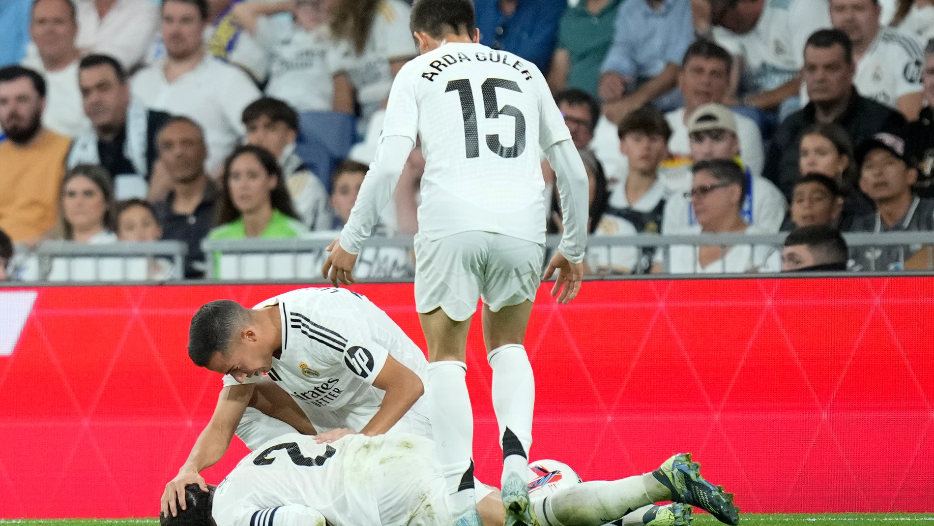 Real Madrid's Lucas Vazquez checks on his teammate Dani Carvajal during the La Liga soccer match between Real Madrid and Villareal in Madrid, Spain, on Saturday, Oct. 5, 2024. (AP Photo/Bernat Armangue)