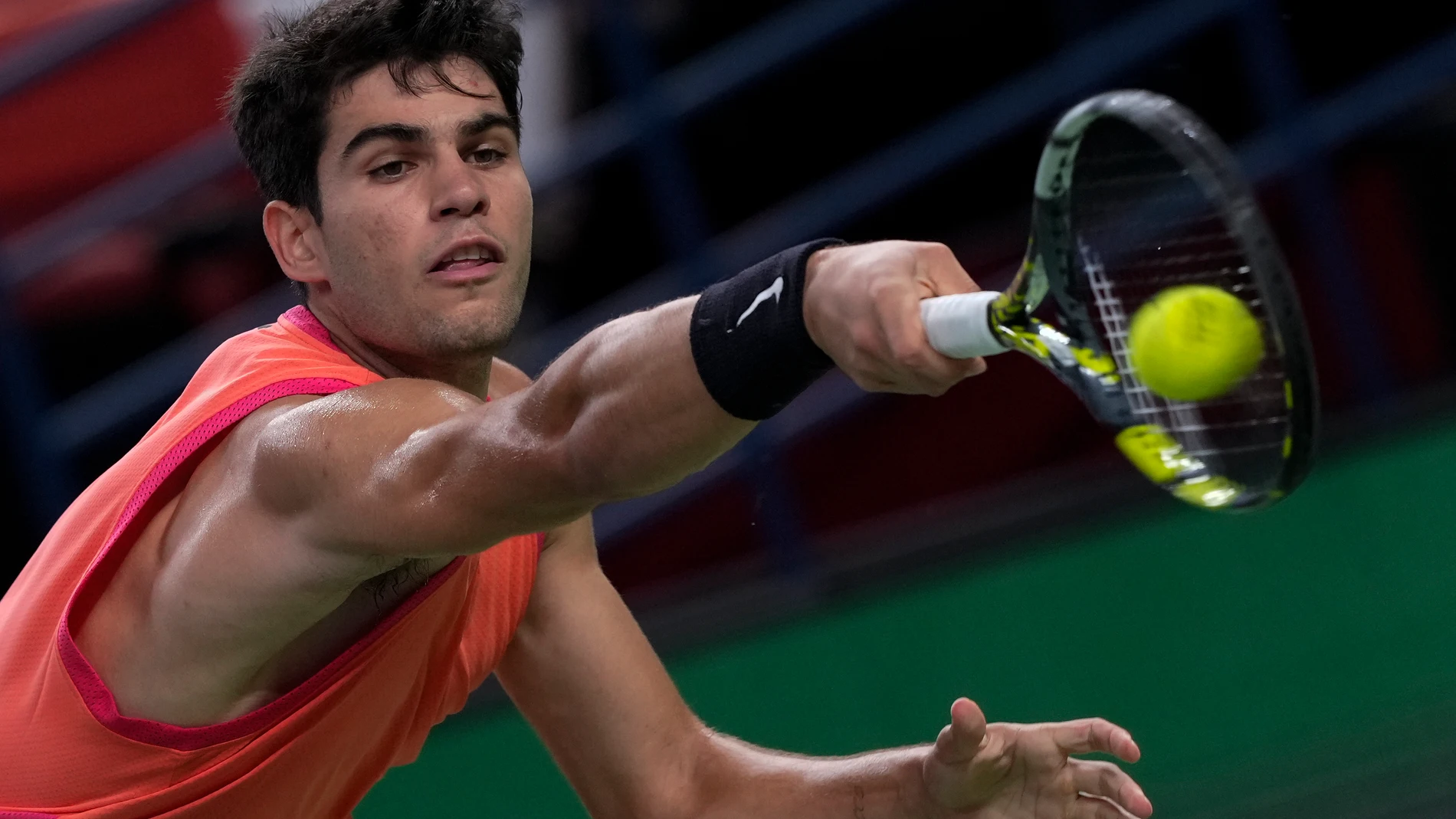 Carlos Alcaraz of Spain returns a backhand shot to Wu Yibing of China during the men's singles match of the Shanghai Masters tennis tournament at Qizhong Forest Sports City Tennis Center in Shanghai, China, Sunday, Oct. 6, 2024. (AP Photo/Andy Wong)