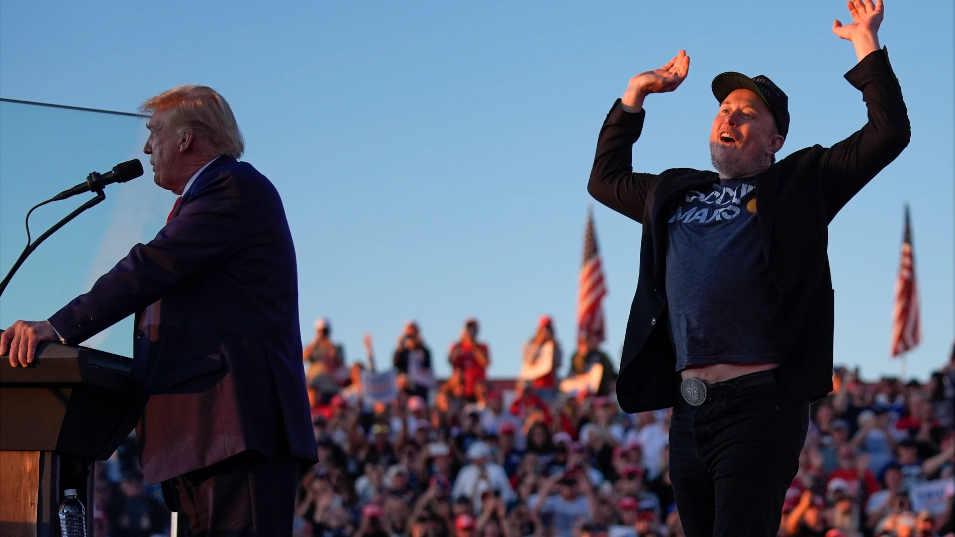 Elon Musk jumps on the stage as Republican presidential nominee former President Donald Trump speaks at a campaign rally at the Butler Farm Show, Saturday, Oct. 5, 2024, in Butler, Pa. (AP Photo/Evan Vucci)