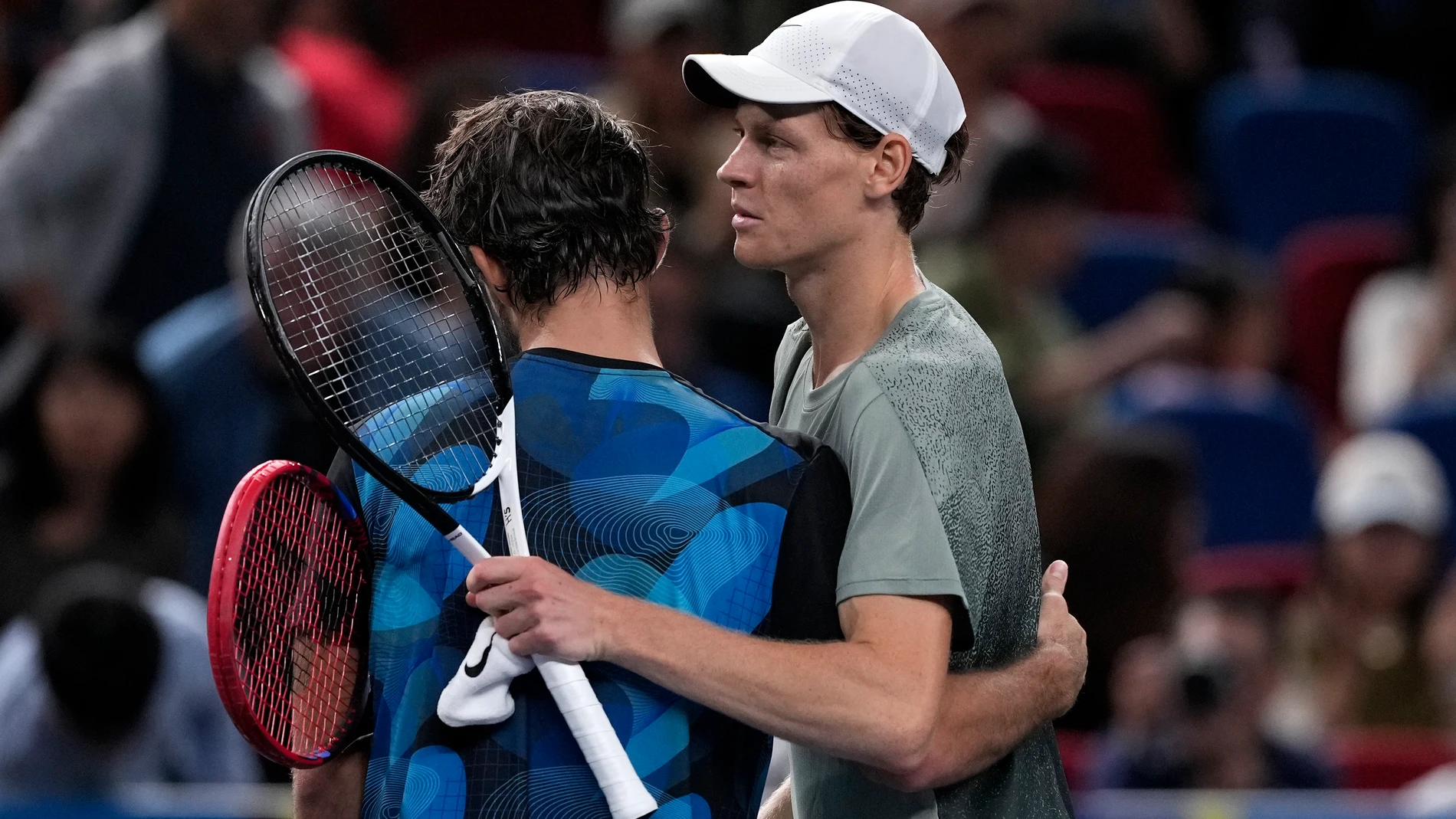 Jannik Sinner of Italy, right, hugs with Tomas Machac of the Czech Republic after winning in their men's singles semifinals match of the Shanghai Masters tennis tournament at Qizhong Forest Sports City Tennis Center in Shanghai, China, Saturday, Oct. 12, 2024. (AP Photo/Andy Wong)