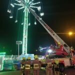 Bomberos de Zaragoza con la autoescala frente a la atracción del columpio gigante este domingo de madrugada en el recinto ferial de Valdespartera, donde fueron restacadas 14 personas.