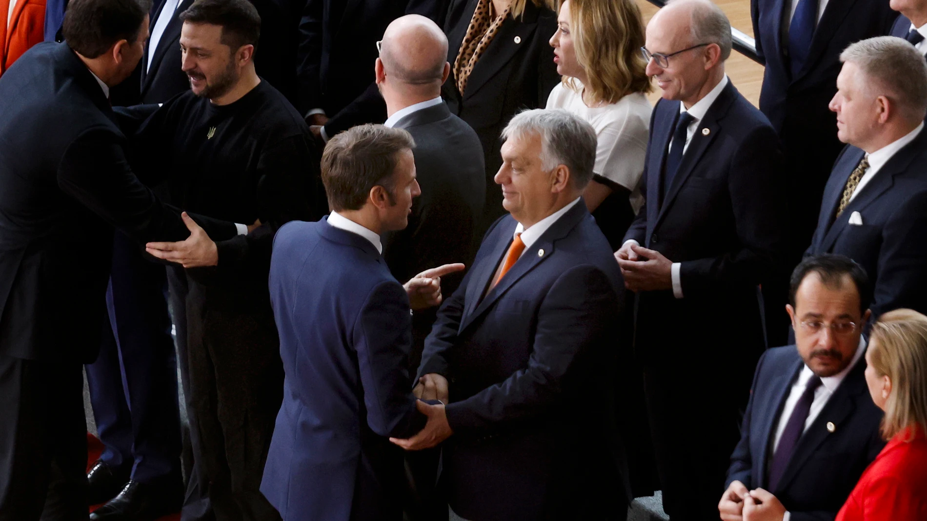 French President Emmanuel Macron, left, talks to Hungary's Prime Minister Viktor Orban as they arrive with EU leaders for a group photo during an EU summit in Brussels, Thursday, Oct. 17, 2024. (AP Photo/Omar Havana)