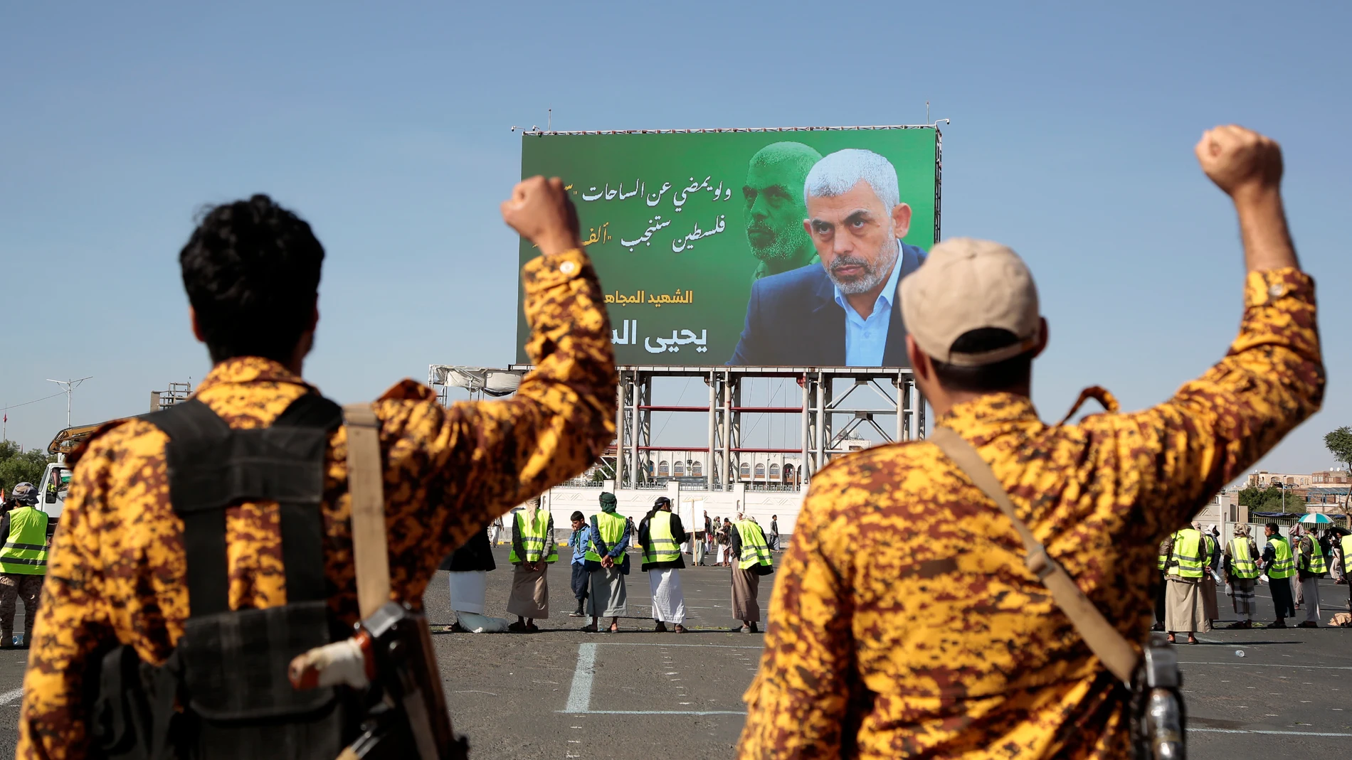 Yemeni soldiers shout slogans in front of a billboard showing Hamas leader Yahya Sinwar during an anti-Israel rally in Sanaa, Yemen, Friday, Oct. 18, 2024. Arabic reads, "martyr Yahya Sinwar". (AP Photo/Osamah Abdulrahman)