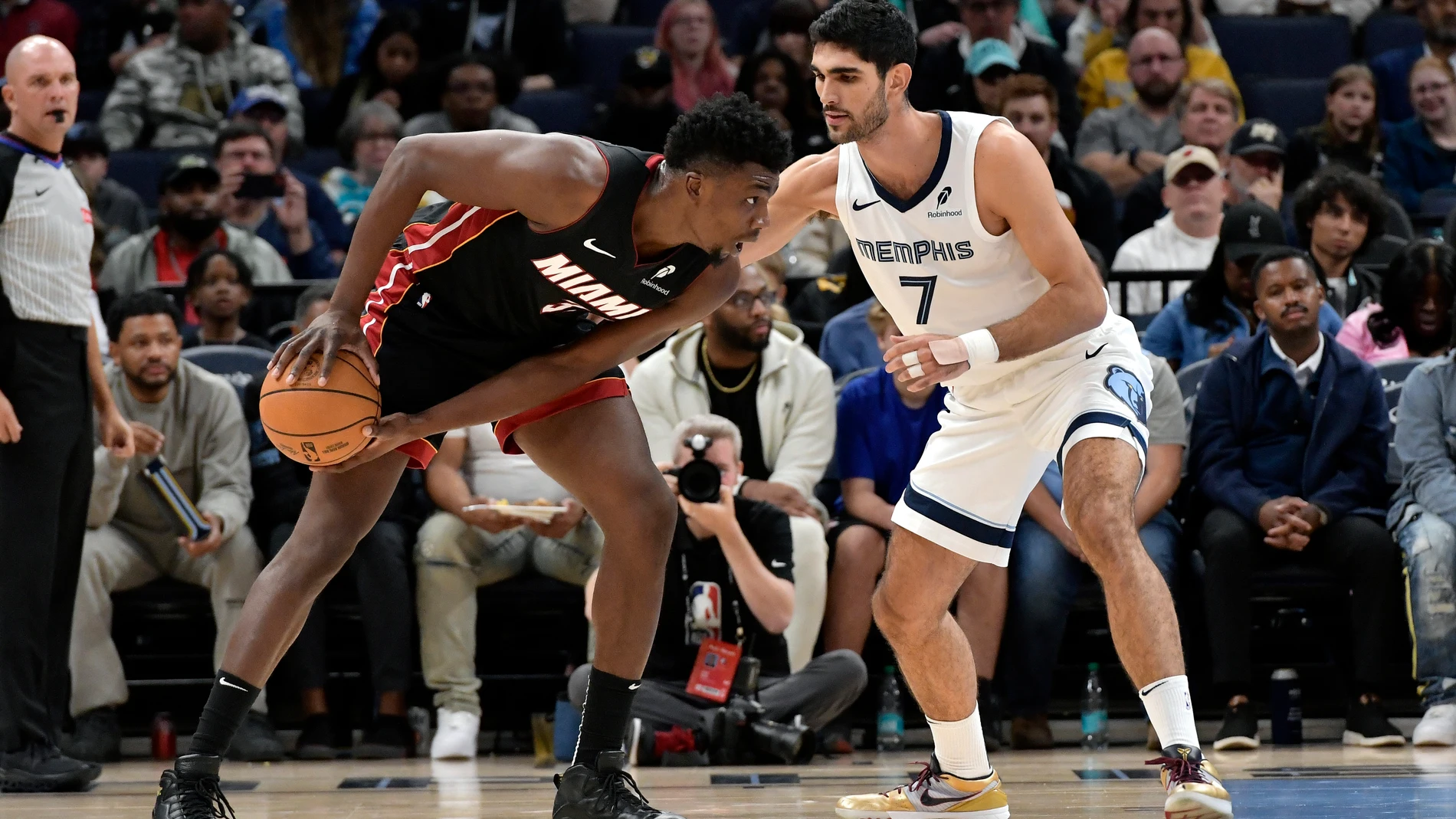 Miami Heat center Thomas Bryant (31) handles the ball against Memphis Grizzlies forward Santi Aldama (7) in the first half of an NBA preseason basketball game Friday, Oct. 18, 2024, in Memphis, Tenn. (AP Photo/Brandon Dill)