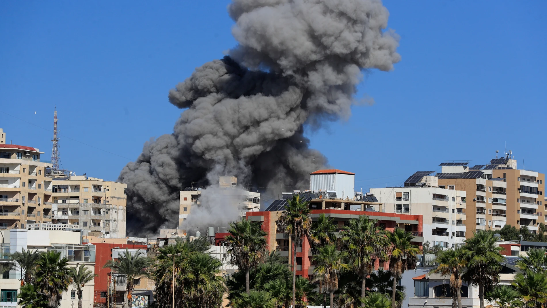 Smoke rises from buildings hit in an Israeli airstrike in Tyre, Lebanon, Wednesday, Oct. 23, 2024. (AP Photo/Mohammad Zaatari)
