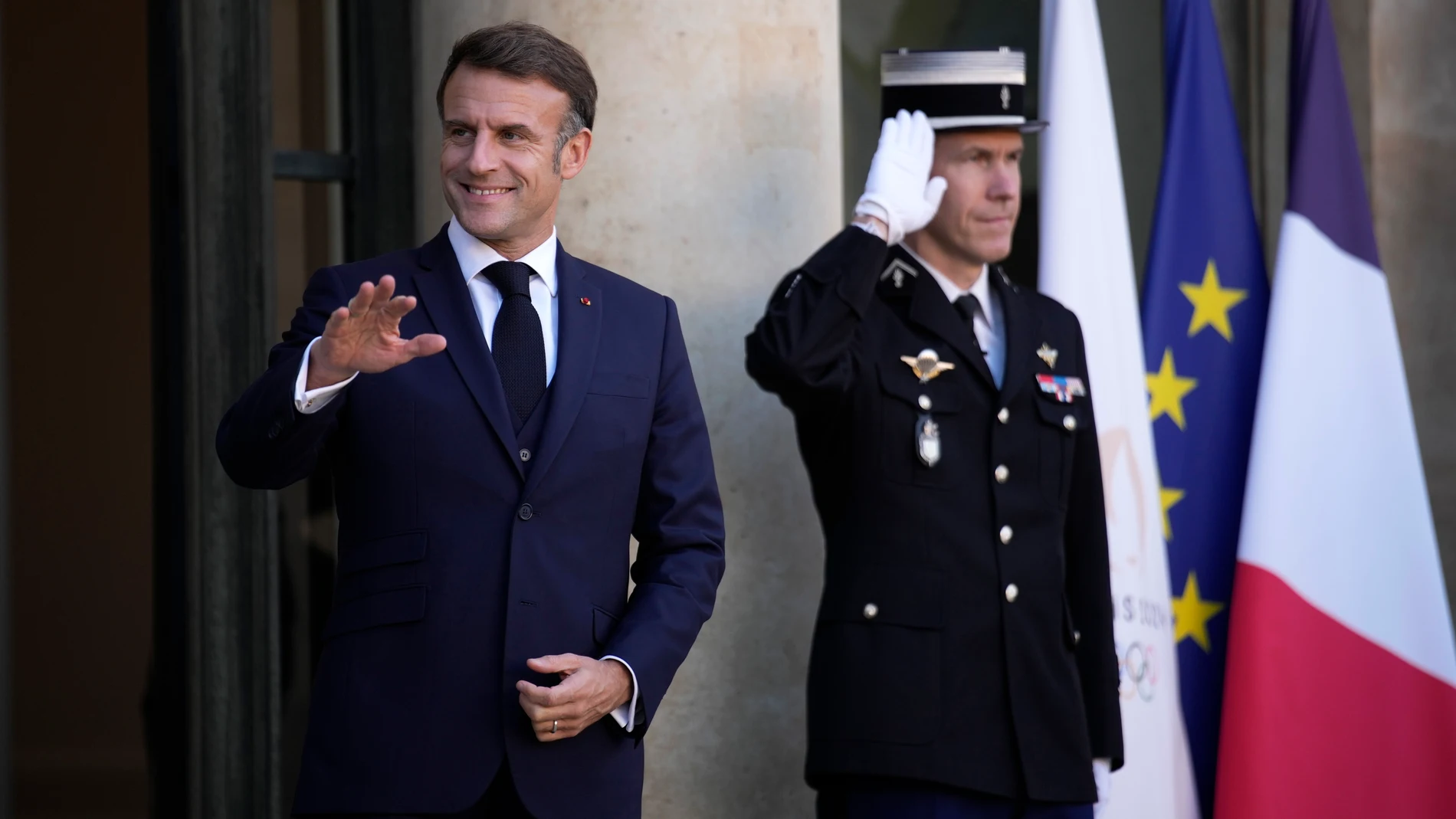 French President Emmanuel Macron waves Wednesday, Oct. 23, 2024 at the Elysee Palace in Paris. (AP Photo/Louise Delmotte)